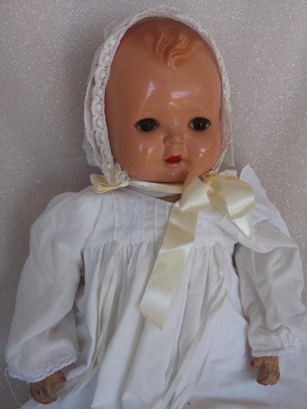 German Buschow & Beck c1900s baby 19 . 5" (49cm) swivel: German Buschow & Beck c1900s baby 19 . 5" (49cm) swivel celluloid head with Mineva mark, molded brown curls, stationery brown eyes, real lashes, open mouth with two teeth . Cloth body with kapok fill 