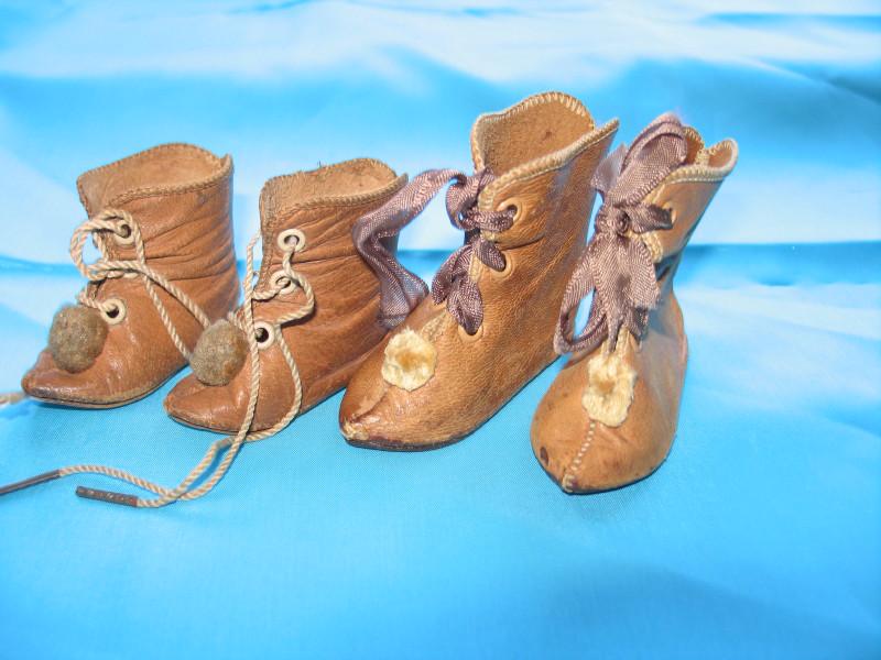 Two pair 1890s French Beaudelot doll shoes . Tan: Two pair 1890s French Beaudelot doll shoes . Tan leather lace-up ankle boots with pom-poms, size 6 (6cm) and size 8 (7 . 5cm) all in excellent condition .