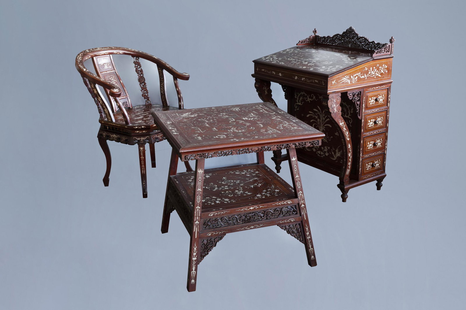 A three-piece Vietnamese bone inlaid wooden bureau: Full title: A three-piece Vietnamese bone inlaid wooden bureau ensemble with floral design and animated landscapes, ca. 1900 Description: H 99 - L 68 - D 53 cm (the davenport) H 85,5 - L 67 - D 62 cm 