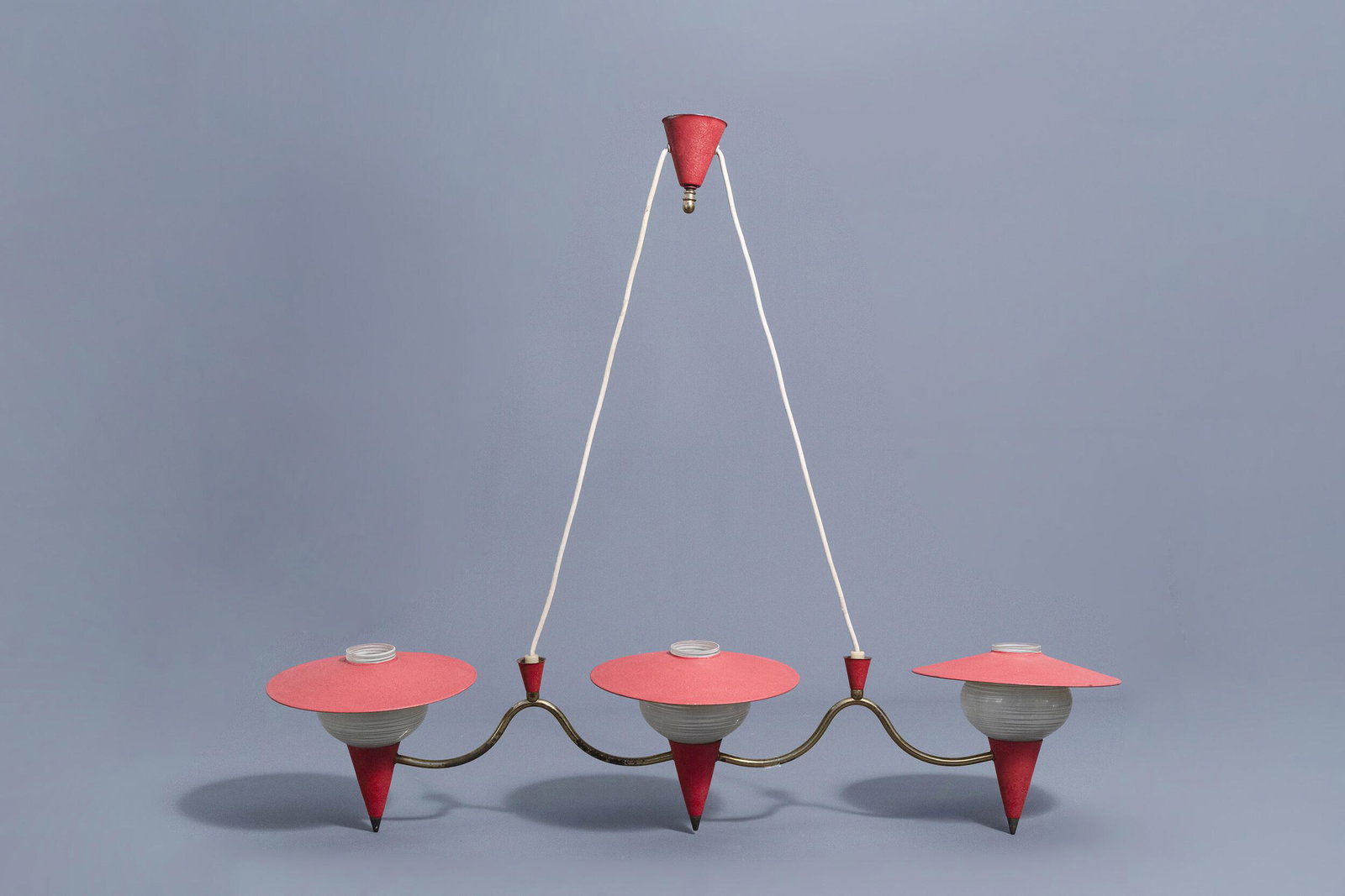 A glass and metal three-light chandelier in the manner: Full title: A glass and metal three-light chandelier in the manner of Jean Royere (1902-1981), 1950's-1960's Description: H 20 - L 99 cm Condition:Please contact us to let us know which lots are of in