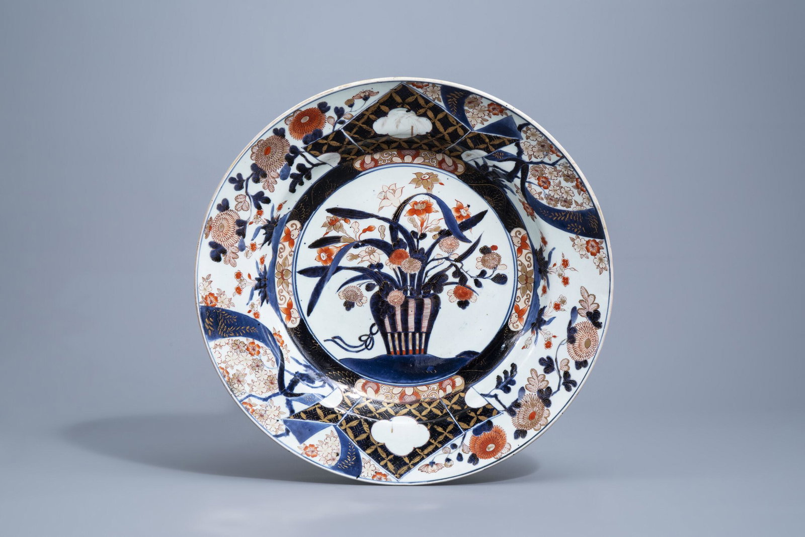 A large Japanese Imari charger with a flower basket and: Full title: A large Japanese Imari charger with a flower basket and floral design, Edo, 18th C. Description: H 9,6 cm - Dia.: 55,5 cm Condition:Please contact us to let us know which lots are of inter