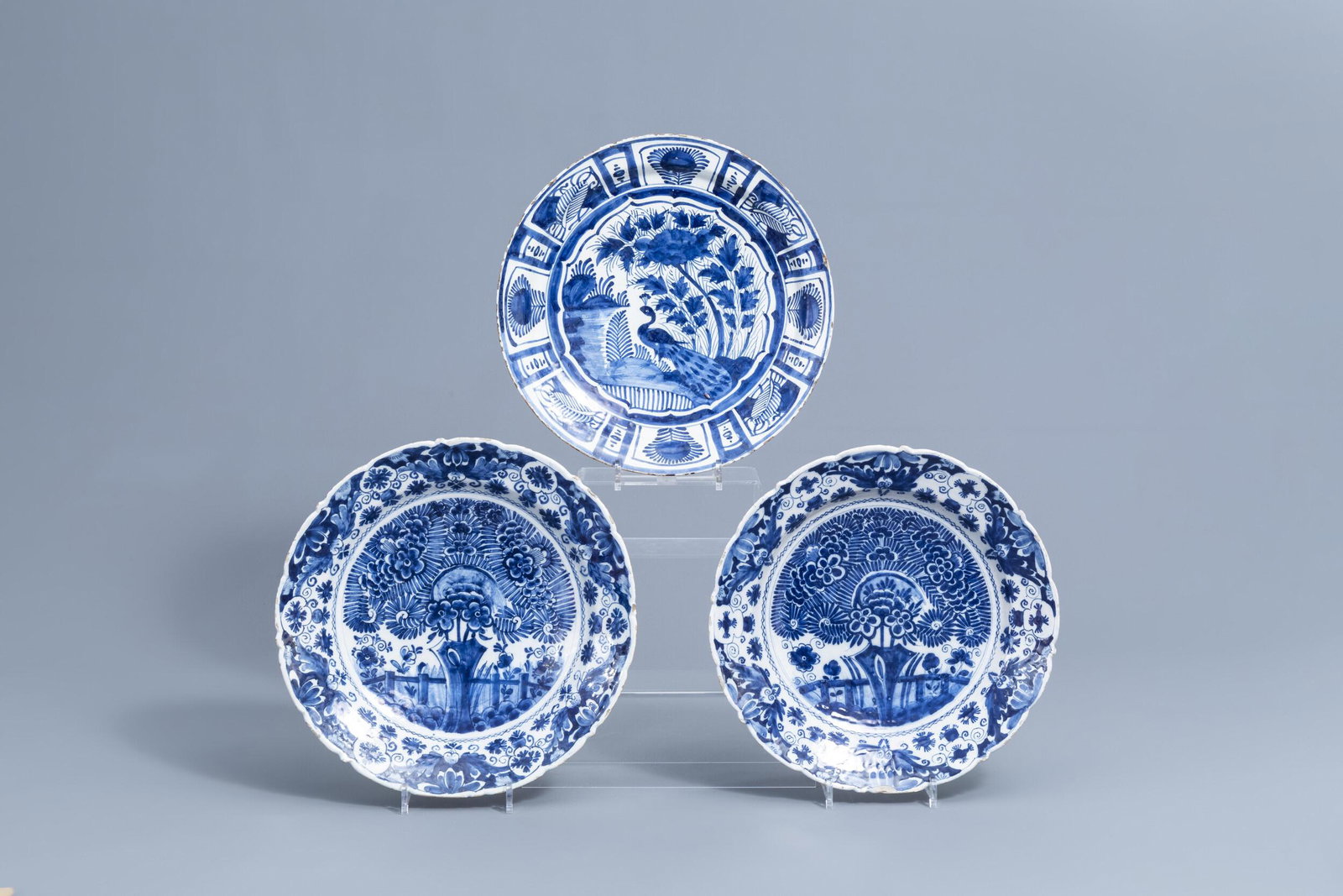 A pair of Dutch Delft blue and white 'tea tree': Full title: A pair of Dutch Delft blue and white 'tea tree' chargers and one with a peacock, 18th C. Description: Dia.: 36,2 - 34 cm The pair marked 'BP' for the "De Blompot" workshop. Condition:Pleas