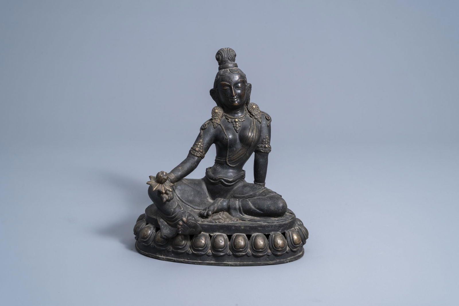 A Sino-Tibetan bronze figure of Tara holding a lotus, (1 of 10)