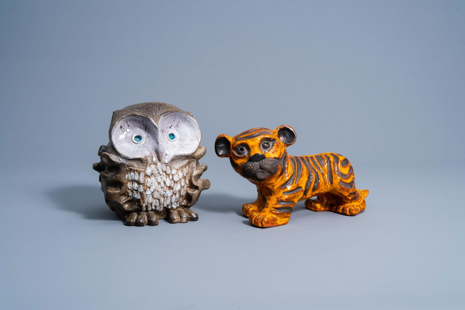 A tiger and an owl in polychrome glazed terracotta, (1 of 7)