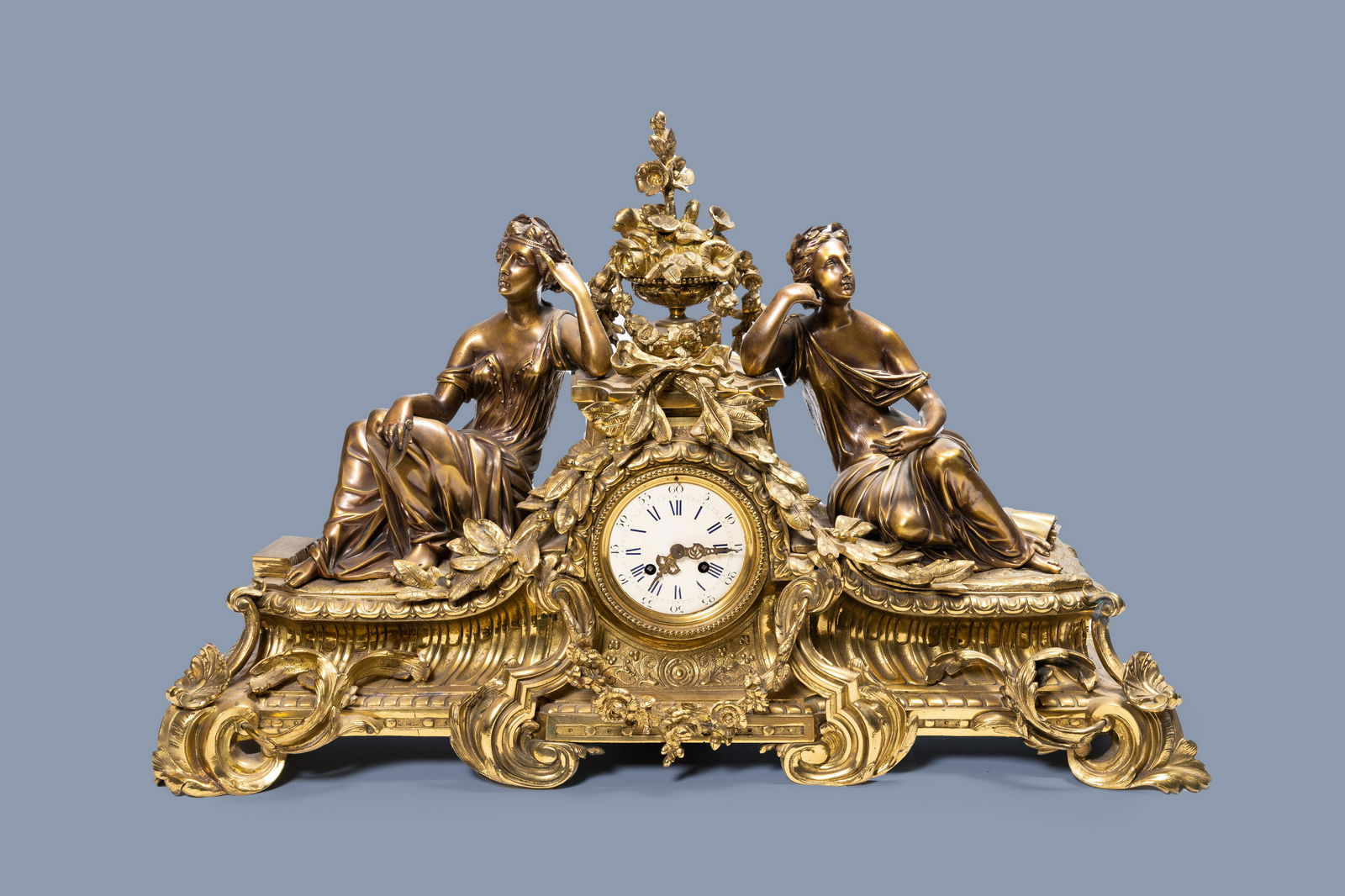 A large French gilt brass mantel clock depicting (1 of 9)