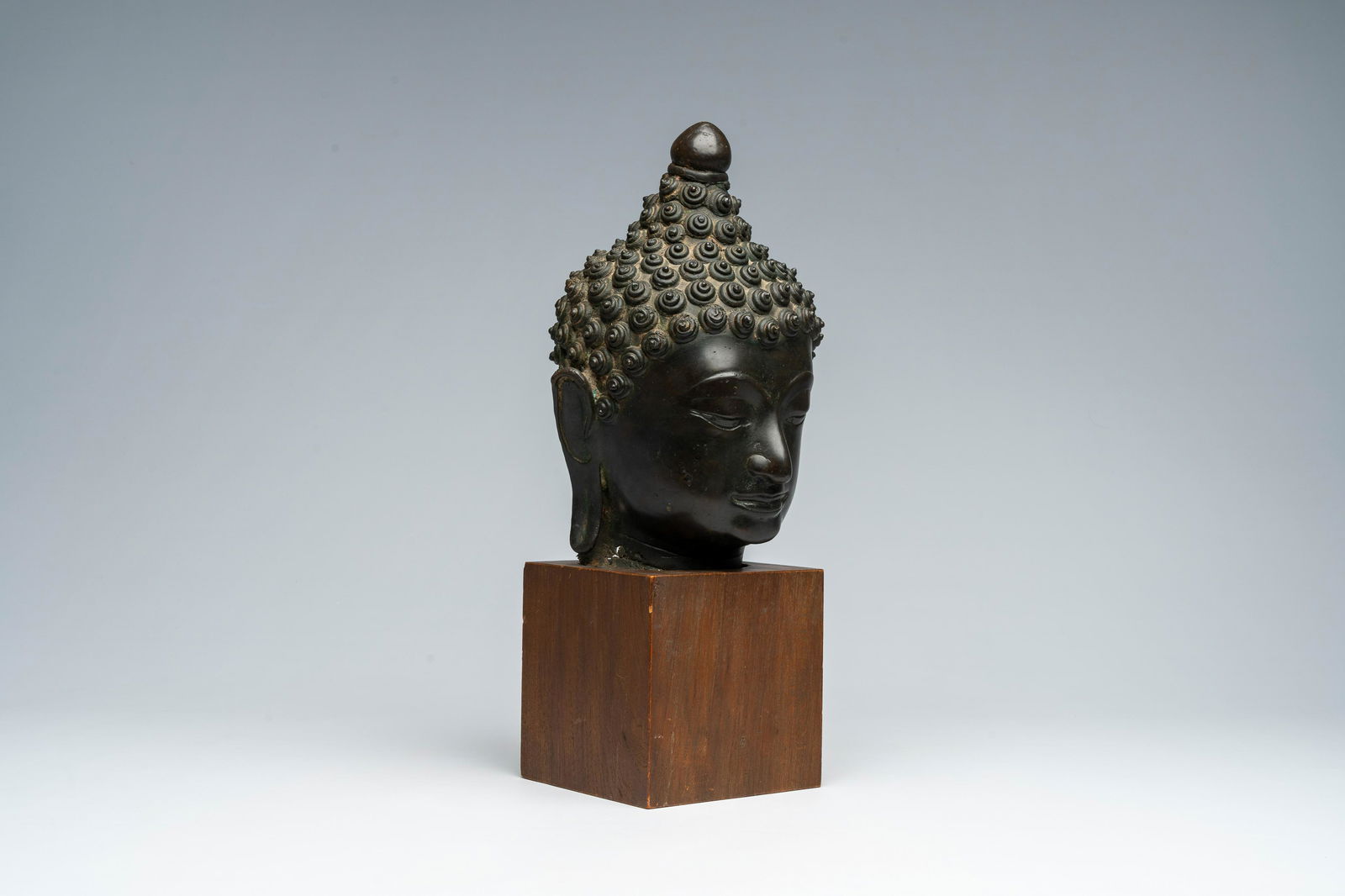 A patinated bronze head of Buddha, Burma or Thailand, 19th C. (1 of 8)