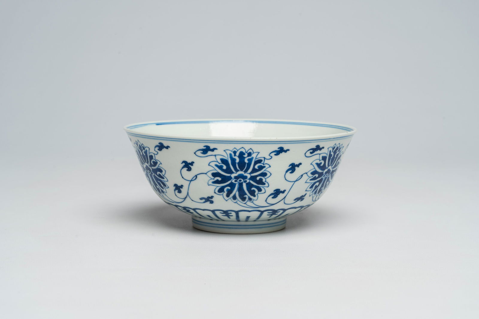 A Chinese blue and white lotus scroll bowl, Guangxu mark, 19th/20th C. (1 of 7)