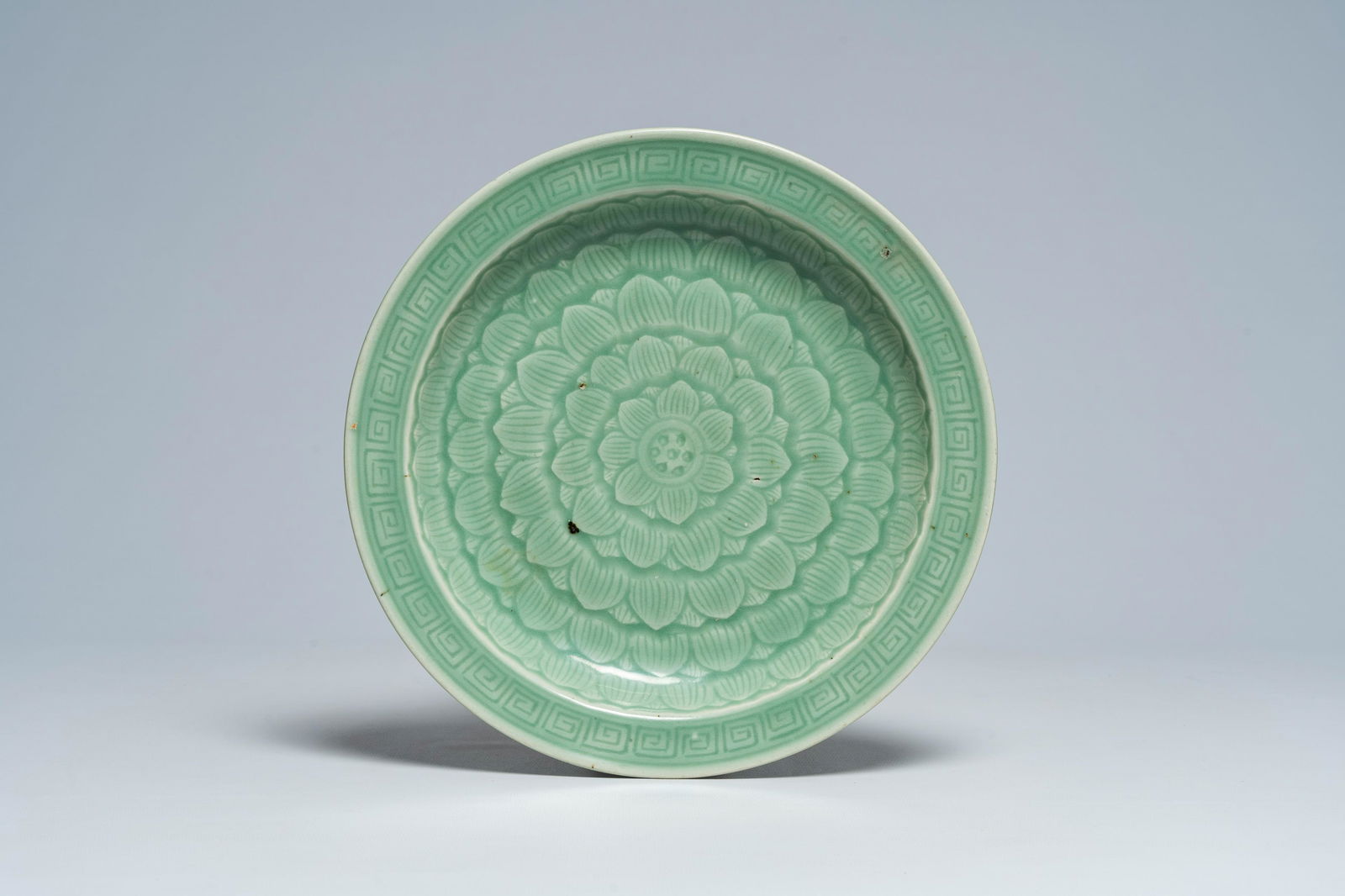 A Chinese celadon dish with incised lotus design, 19th C. (1 of 2)