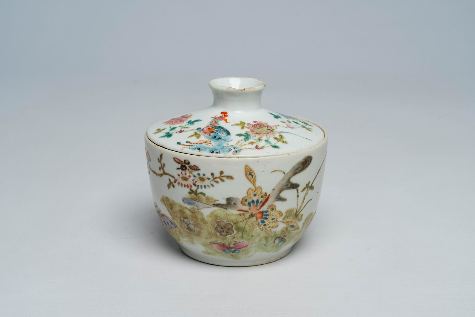 A Chinese famille rose bowl and cover with a phenix, butterflies and floral design, Tongzhi mark and (1 of 7)