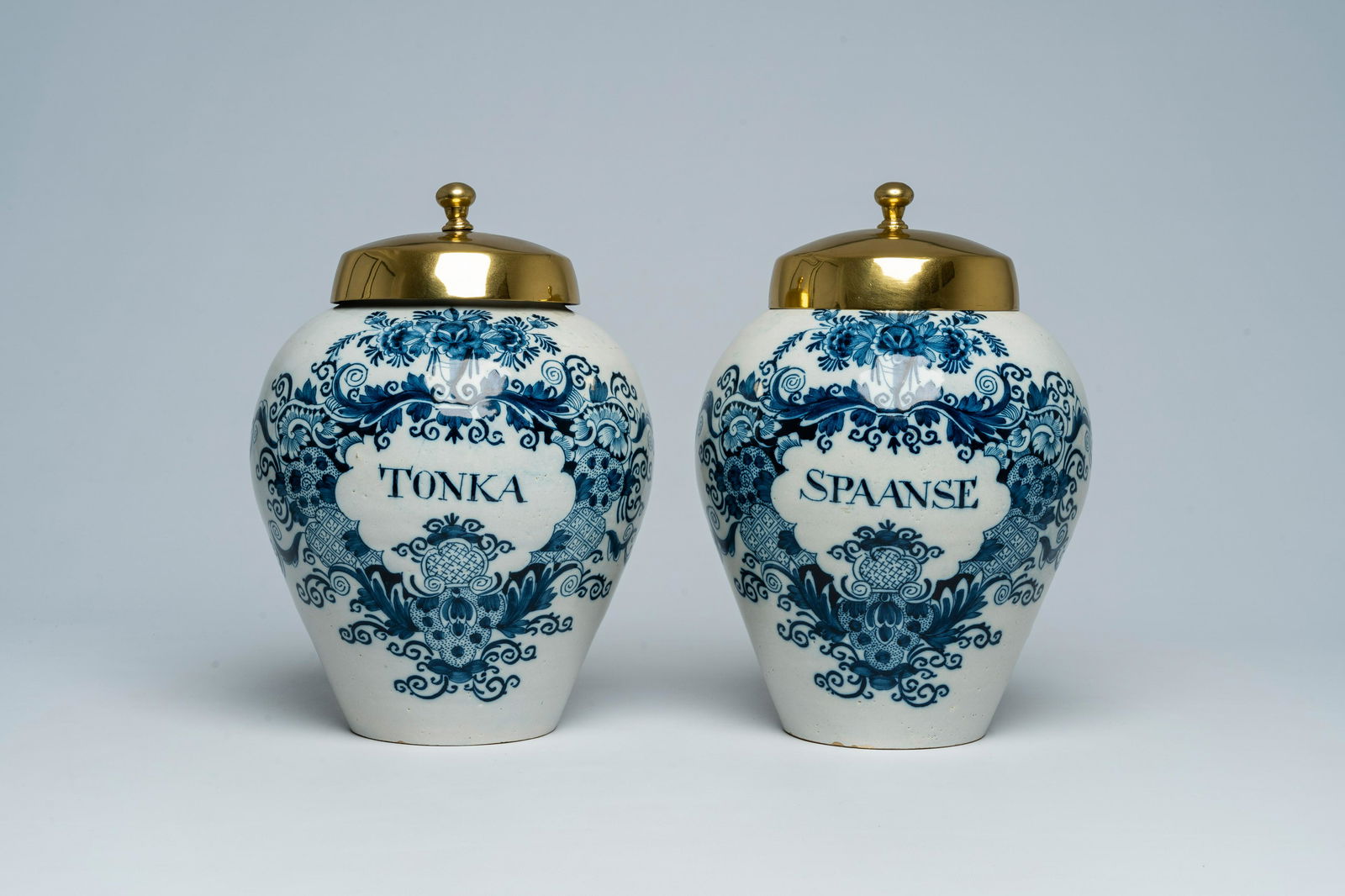 A pair of Dutch Delft blue and white tobacco jars with brass lids, 18th C. (1 of 7)