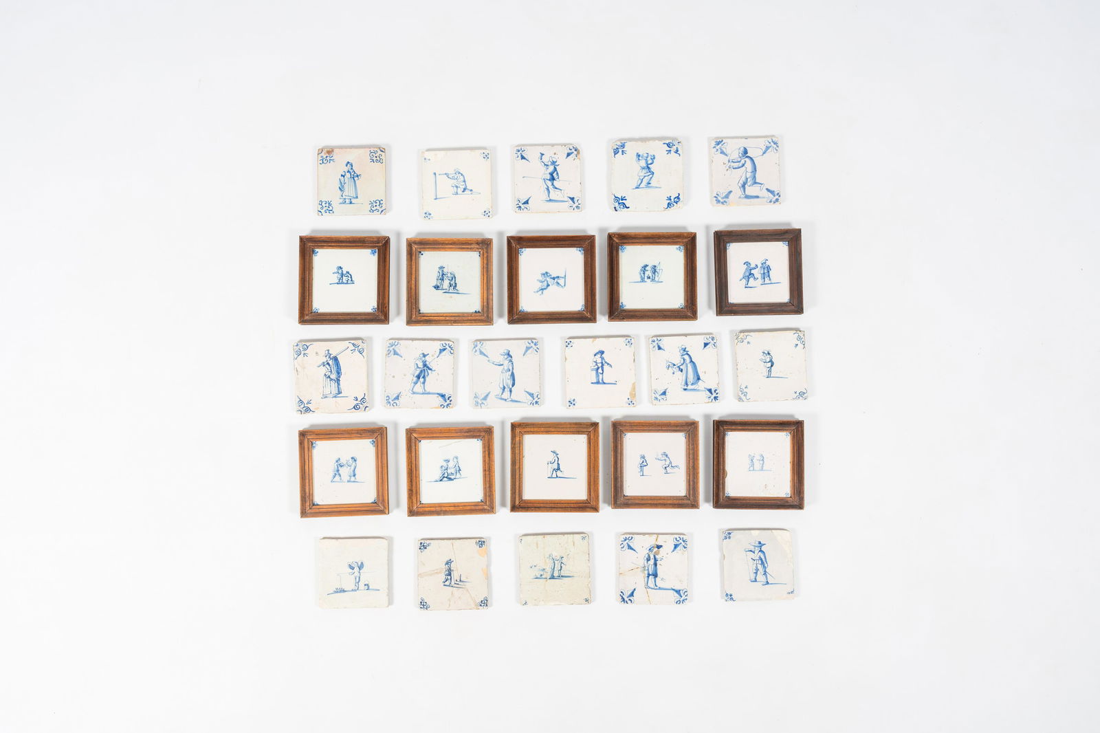 26 blue and white Dutch Delft tiles with large figures and children at play, 17th/19th C. (1 of 2)