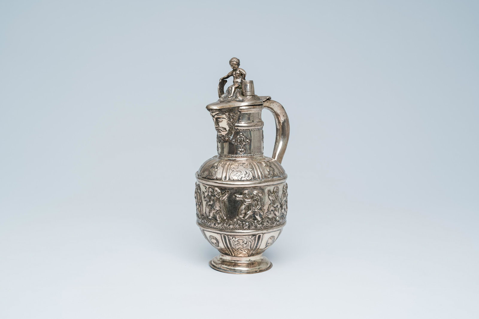 A Dutch historicizing silver jug with a mascaron, dancing peasants and the Amsterdam coat of arms, (1 of 10)