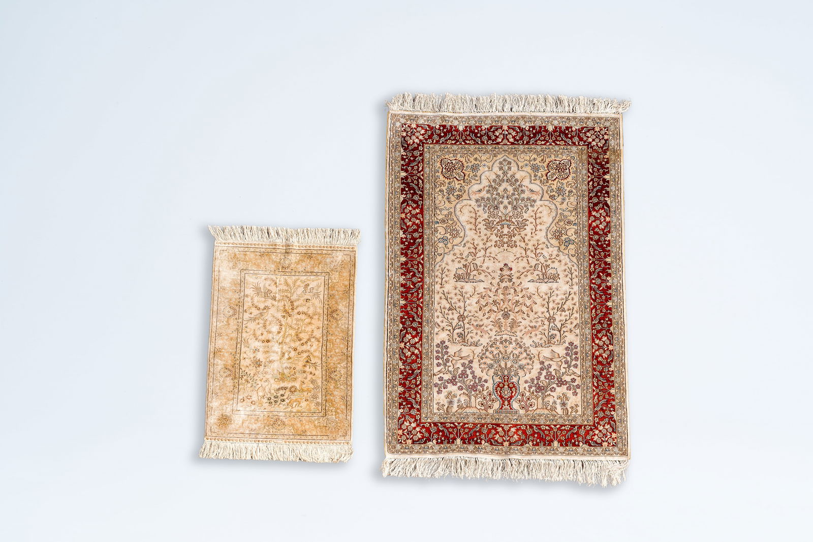 Two Oriental silk rugs with floral design and animals in a landscape, a.o. a Hereke rug, 20th C. (1 of 7)