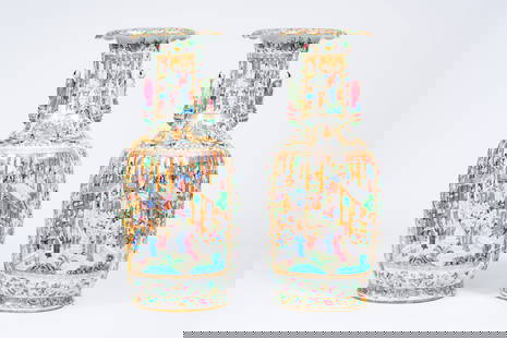 A pair of large ribbed Chinese Canton famille rose vases with palace scenes and the Hehe Er Xian: A pair of large ribbed Chinese Canton famille rose vases with palace scenes and the Hehe Er Xian twins in relief, 19th C. H 86,5 cm