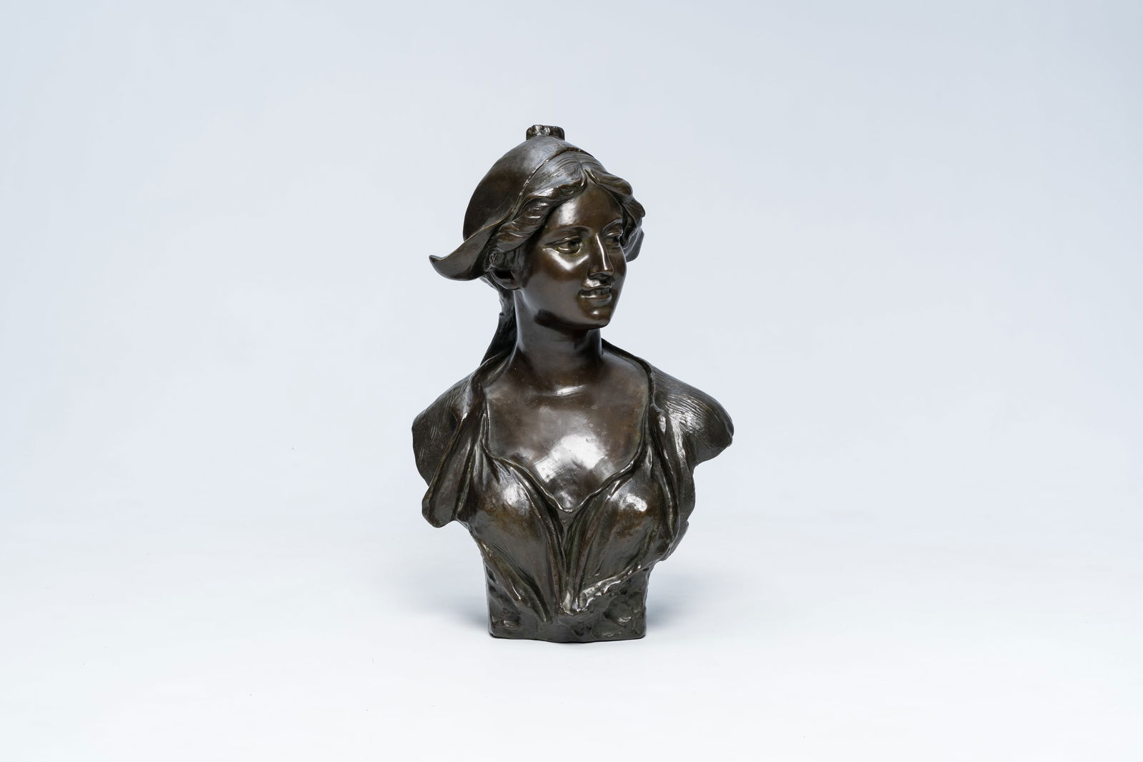 Jef Lambeaux (1852-1908): Bust of a young lady with a headdress, brown patinated bronze: Jef Lambeaux (1852-1908): Bust of a young lady with a headdress, brown patinated bronze H 66 cm The reverse with a Brussels foundry mark in a triangle with clover ('... Bruxelles').