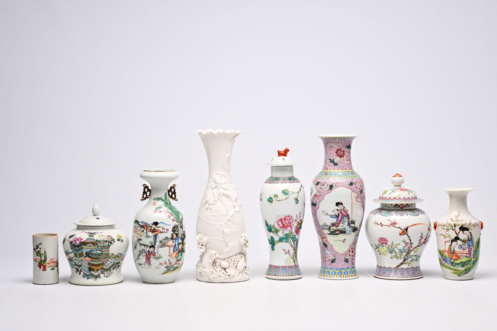 Five various Chinese famille rose and blanc de Chine vases, two jars and covers and a brush pot with: Five various Chinese famille rose and blanc de Chine vases, two jars and covers and a brush pot with figurative design, 19th/20th C. H 37,2 - 22 cm (the tallest and the smallest vase) H 26 - 19 cm (th