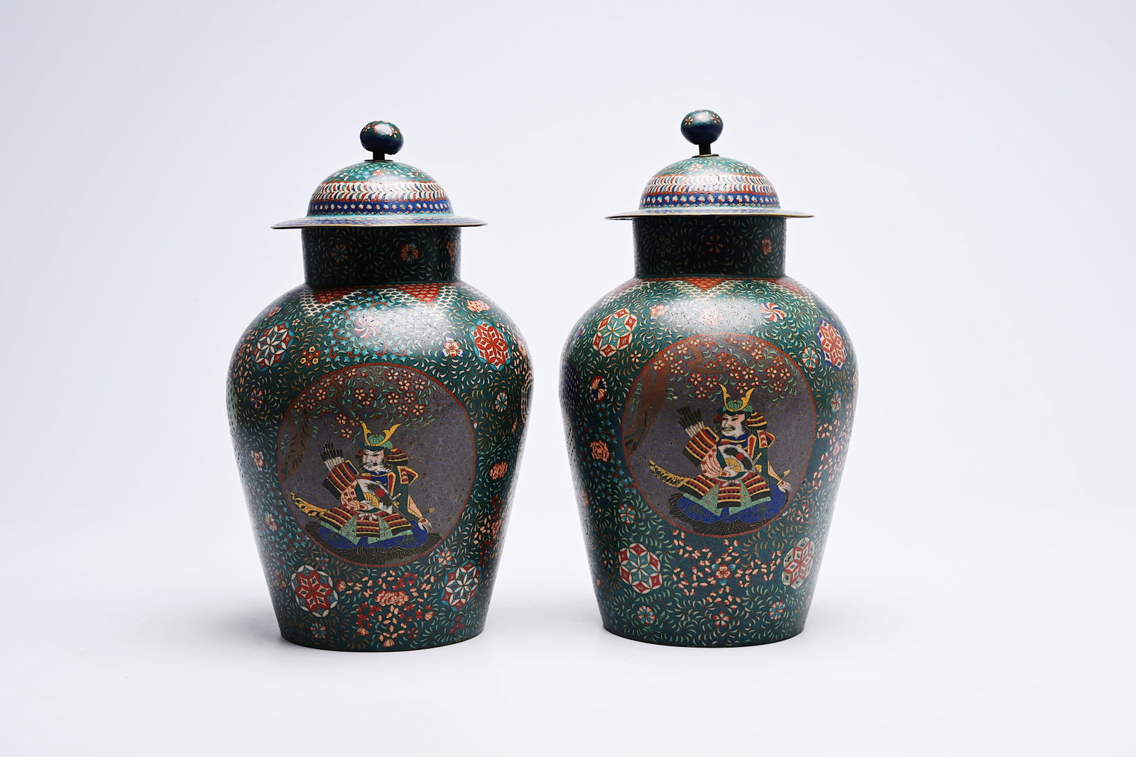 A pair of Japanese cloisonne 'dragon and samurai' vases and covers, Meiji, ca. 1900: A pair of Japanese cloisonne 'dragon and samurai' vases and covers, Meiji, ca. 1900 H 37,4 - 36,3 cm