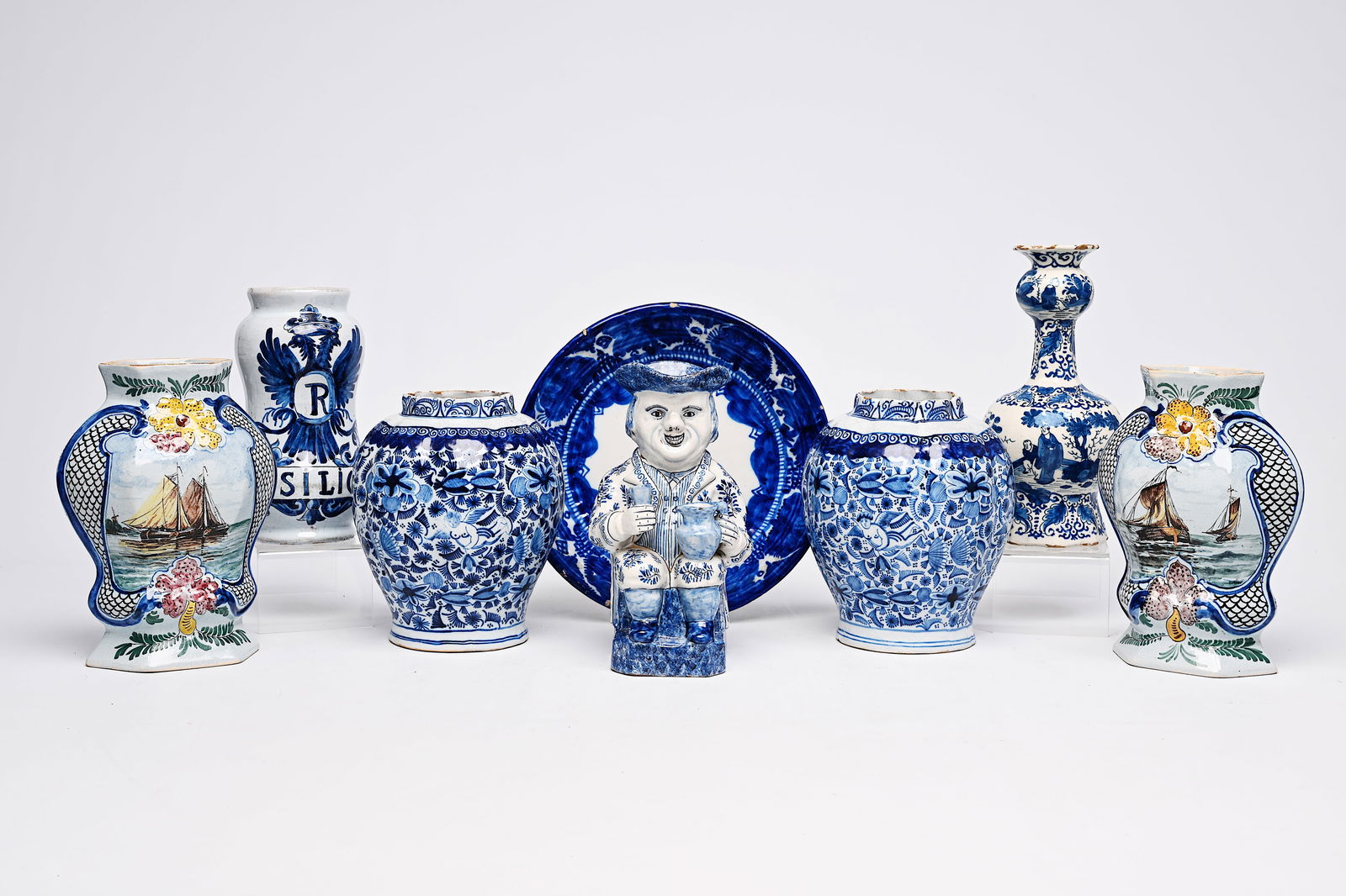 A varied collection of blue, white and polychrome earthenware items, Delft, France and Spain,: A varied collection of blue, white and polychrome earthenware items, Delft, France and Spain, 18th/19th C. H 27 - 21,5 cm (the tallest and the smallest vase) H 23 cm (the albarello) H 24,5 cm (the jug