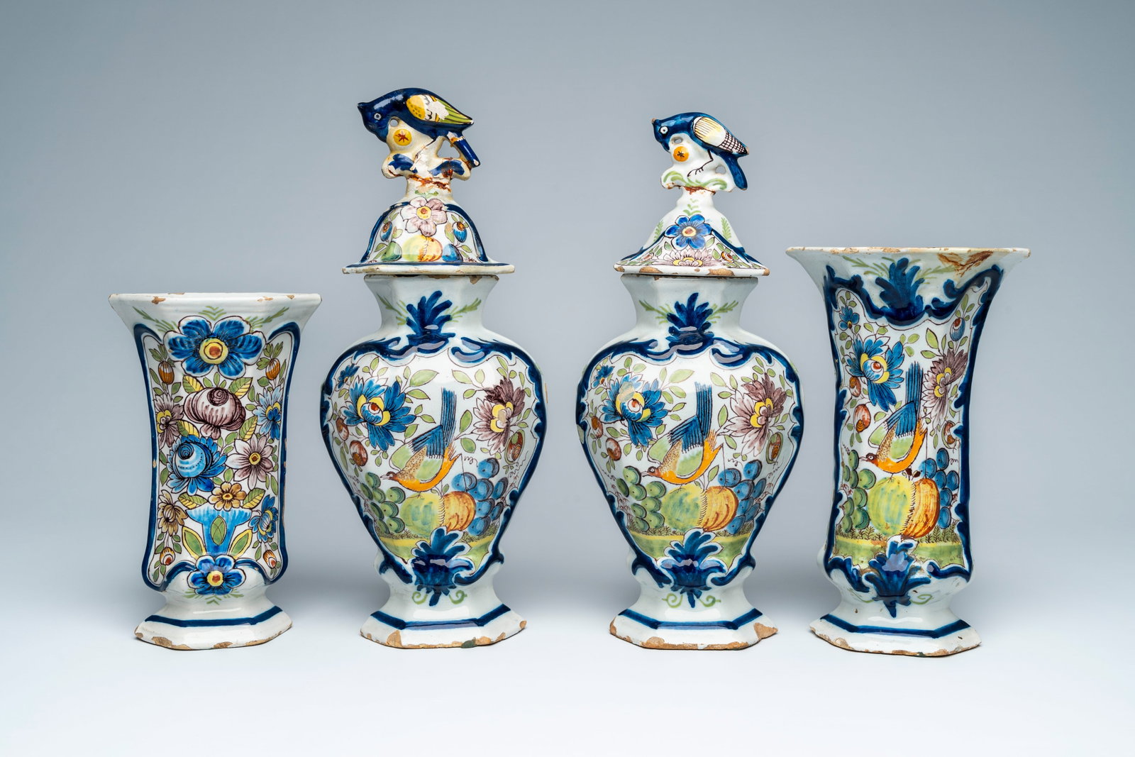 A polychrome Dutch Delft four-piece garniture, 18th C.: A polychrome Dutch Delft four-piece garniture, 18th C. H 35,2 - 22,3 cm (the tallest and the smallest vase)