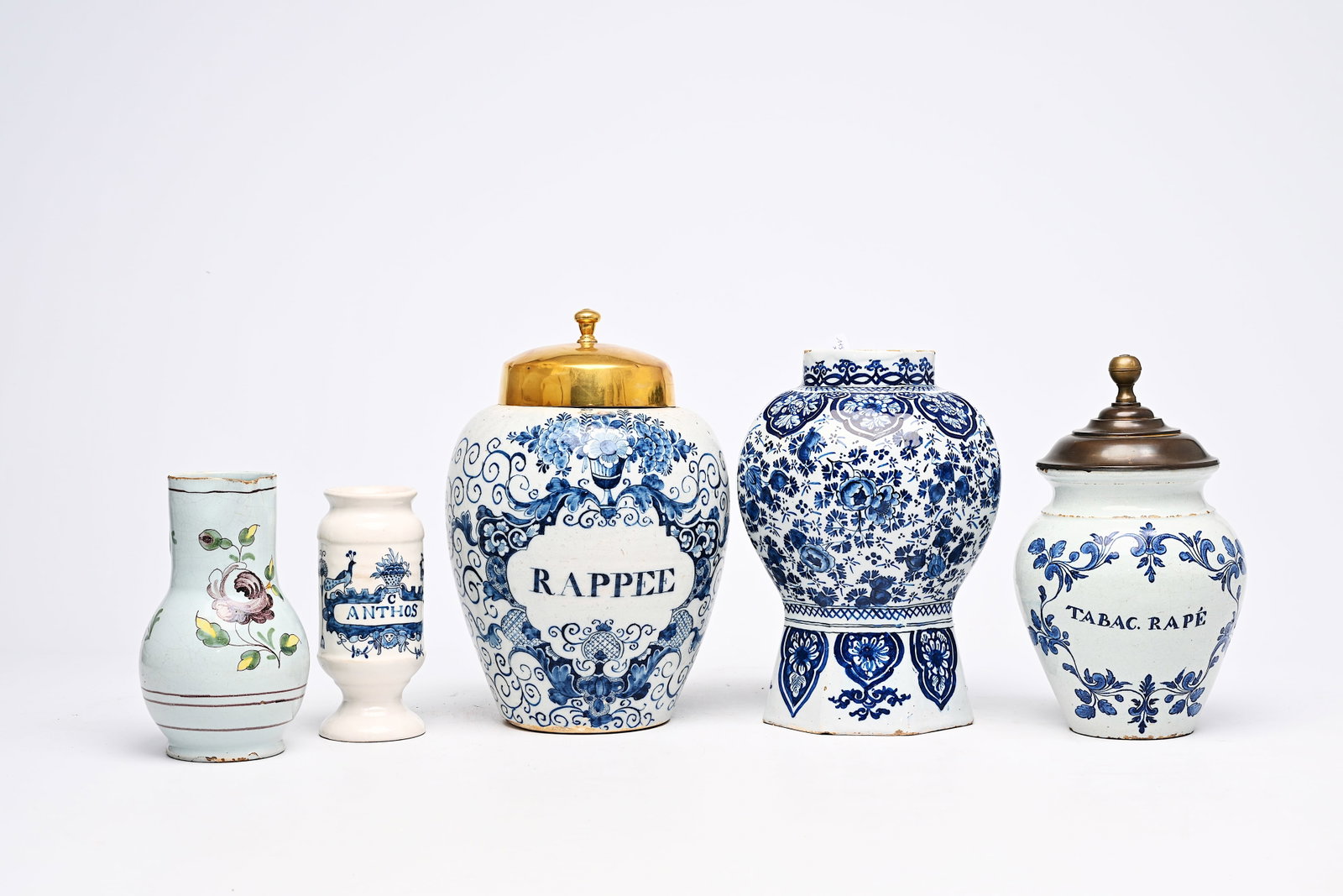 A varied collection of Dutch Delft and French blue and white potter, 18th/19th C.: A varied collection of Dutch Delft and French blue and white potter, 18th/19th C. H 32,2 - 28,5 cm (the tobacco jars with their brass covers) H 28,8 - 18,5 cm (the vase and the drug jar) H 20,3 - L 14
