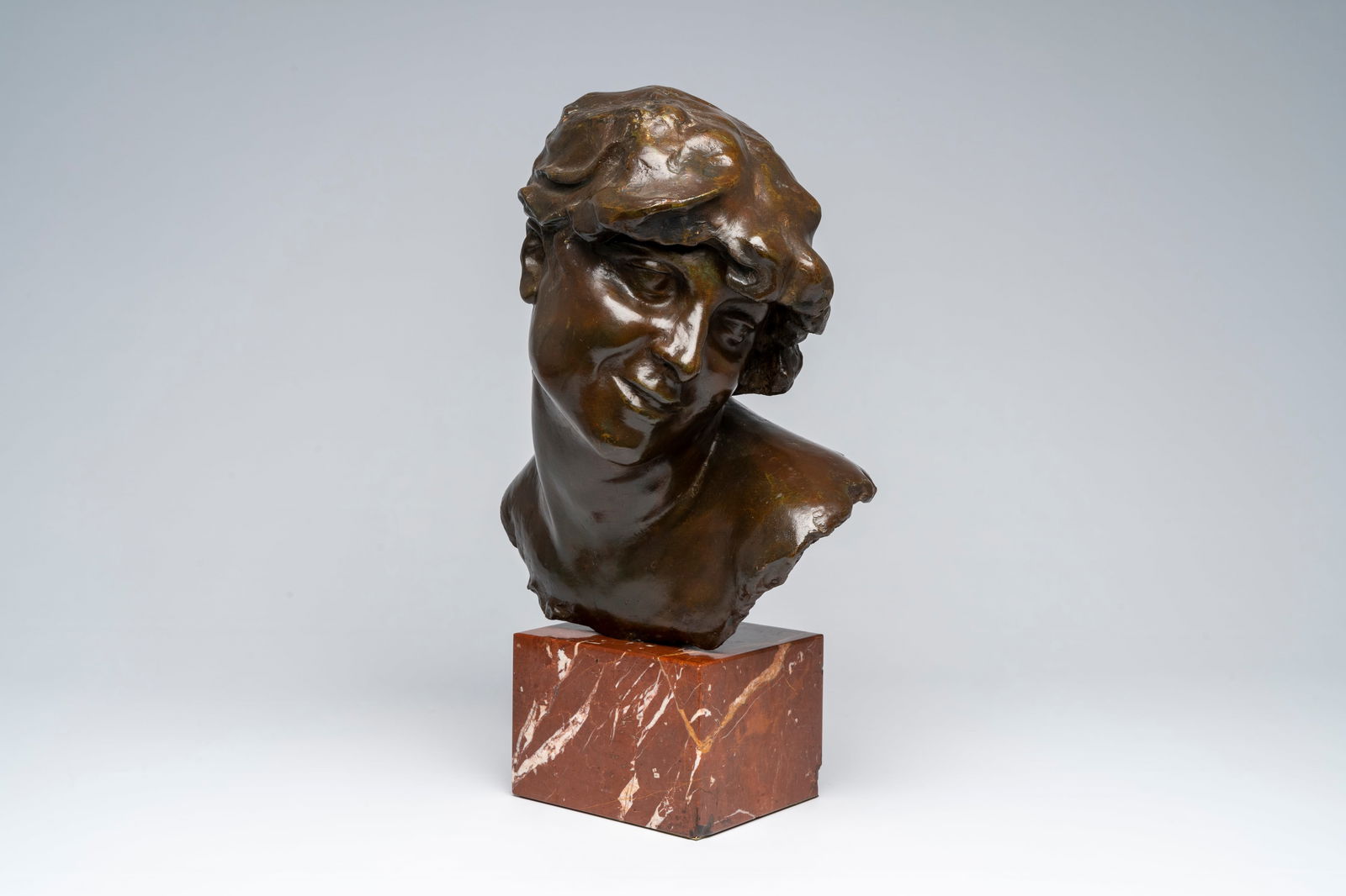 Jef Lambeaux (1852-1908, in the manner of): Bust of a lady, brown patinated bronze on a red marble: Jef Lambeaux (1852-1908, in the manner of): Bust of a lady, brown patinated bronze on a red marble base H 51,2 - 39 cm (with and without base)