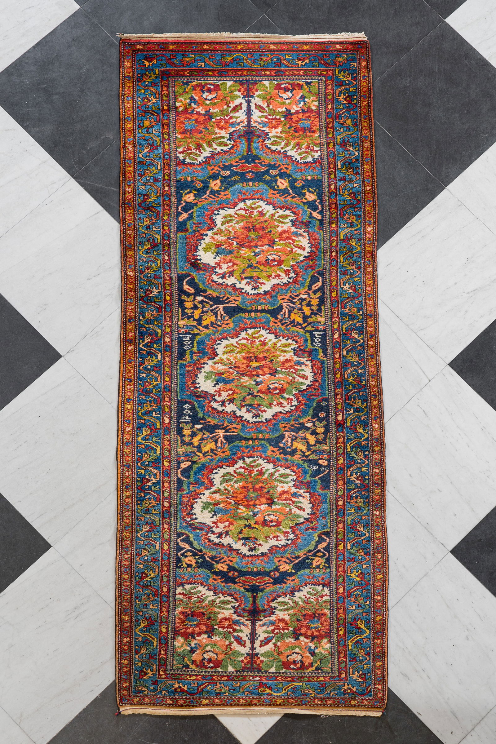 A Persian Bakhtiari runner with floral design, wool on cotton, 20th C. (1 of 10)