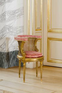 A French gilt wooden Louis XVI style curved fauteuil de bureau with silk and wicker upholstery, late: A French gilt wooden Louis XVI style curved fauteuil de bureau with silk and wicker upholstery, late 19th C. H 78 - L 55 - D 54 cm Provenance: - Sotheby's, Regensburg,'Die Furstliche