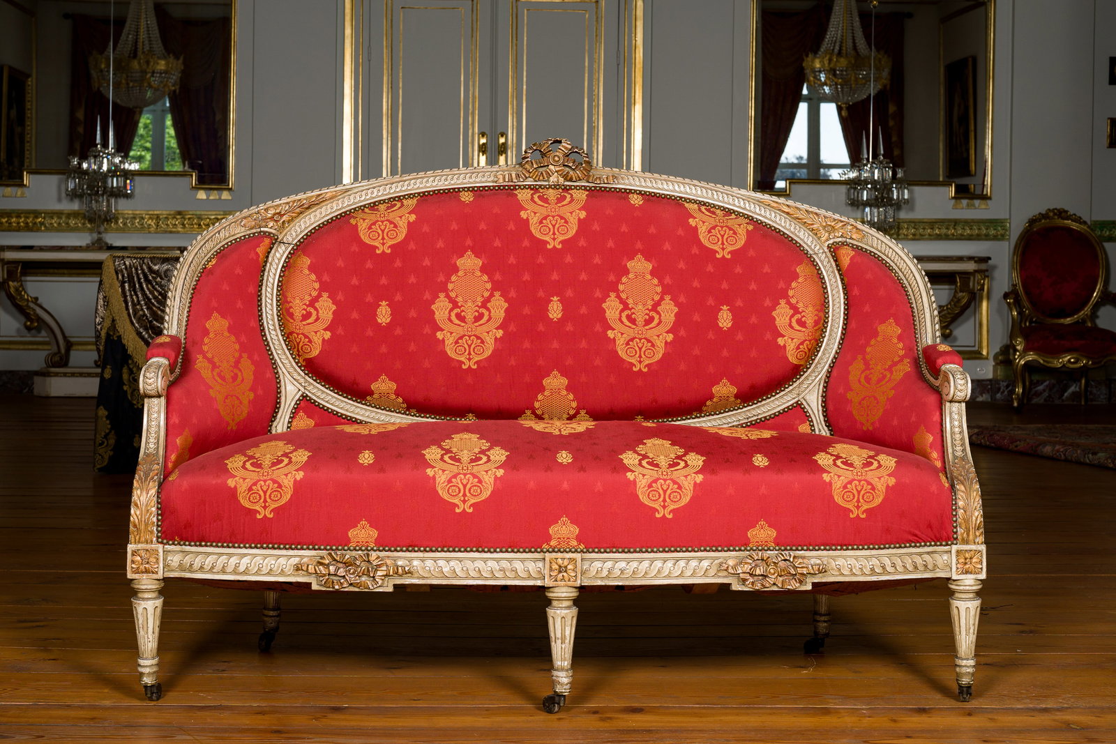 A French Louis XVI style gilt and patinated wooden sofa with empire style fabric upholstery, 19th C.: A French Louis XVI style gilt and patinated wooden sofa with empire style fabric upholstery, 19th C. H 109 - L 159 - D 64 cm