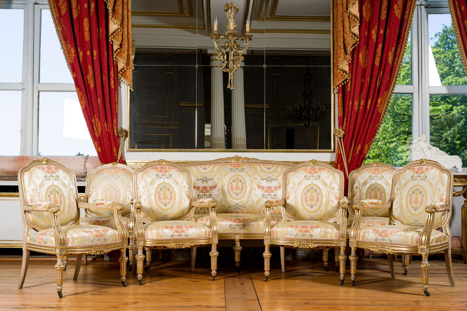 A French Louis XVI style silk upholstered gilt wooden seven-piece salon suite comprising a canape (1 of 8)