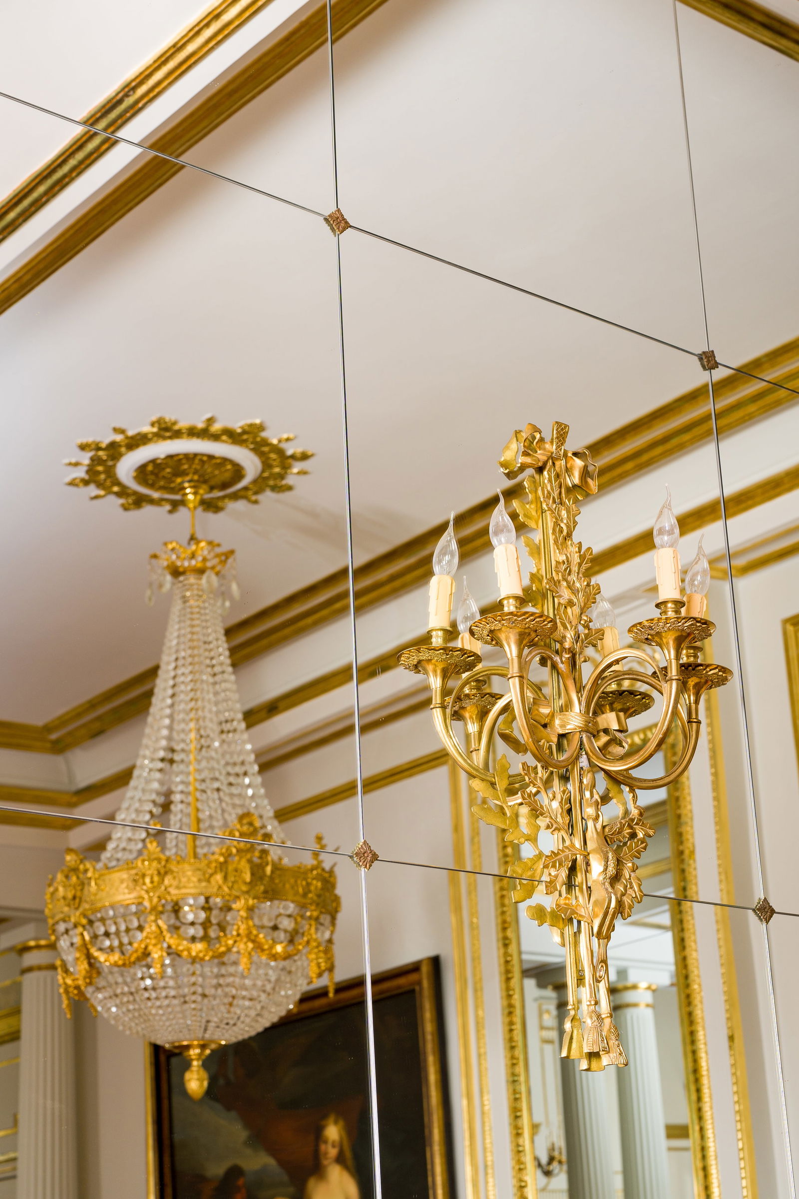 A pair of large French gilt bronze Louis XVI style three-light wall appliques with hunting design, (1 of 4)