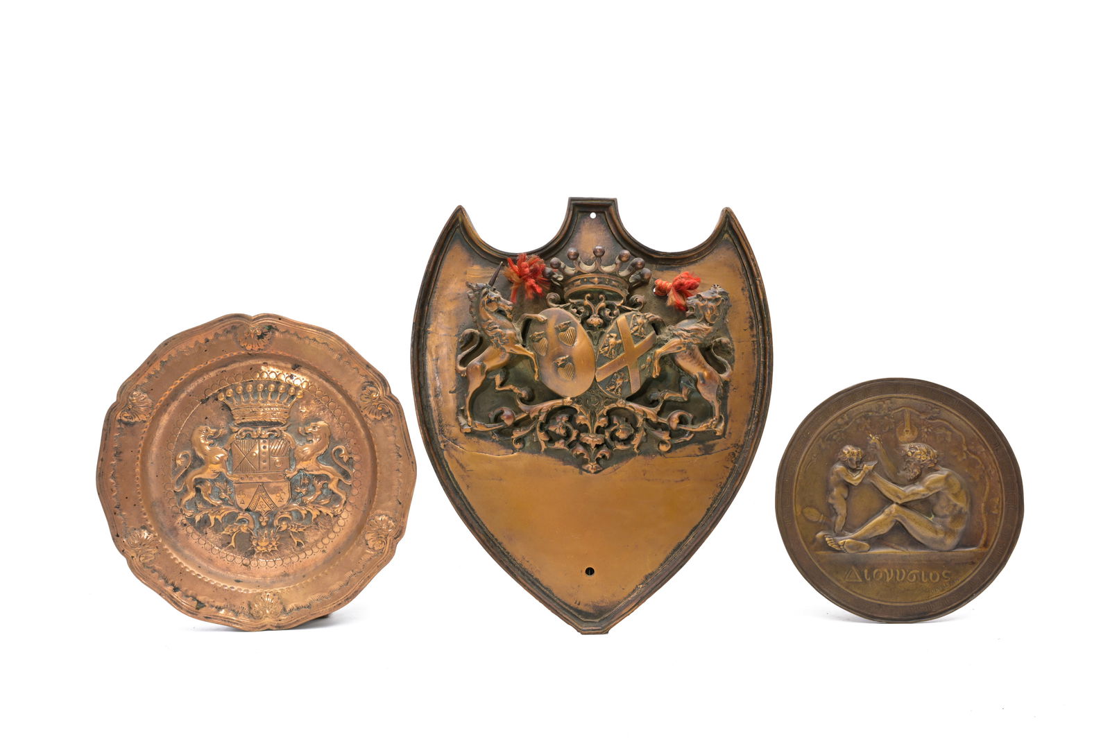 Ferdinand Levillain (1837-1905): The education of Dionysus, patinated bronze and two bronze 'coat of: Ferdinand Levillain (1837-1905): The education of Dionysus, patinated bronze and two bronze 'coat of arms' plaques, 19th/20th C. 35,5 x 30 cm (the largest plaque) Dia.: 26,5 - 20 cm Levillain was a di