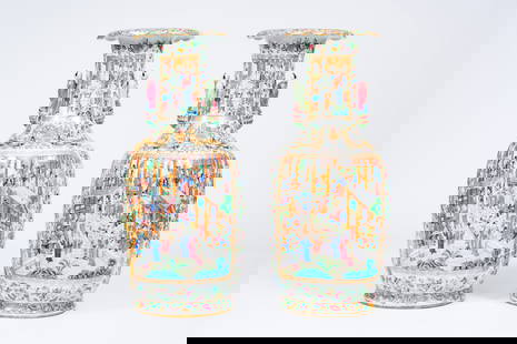A pair of large ribbed Chinese Canton famille rose vases with palace scenes and the Hehe Er Xian: A pair of large ribbed Chinese Canton famille rose vases with palace scenes and the Hehe Er Xian twins in relief, 19th C. H 86,5 cm