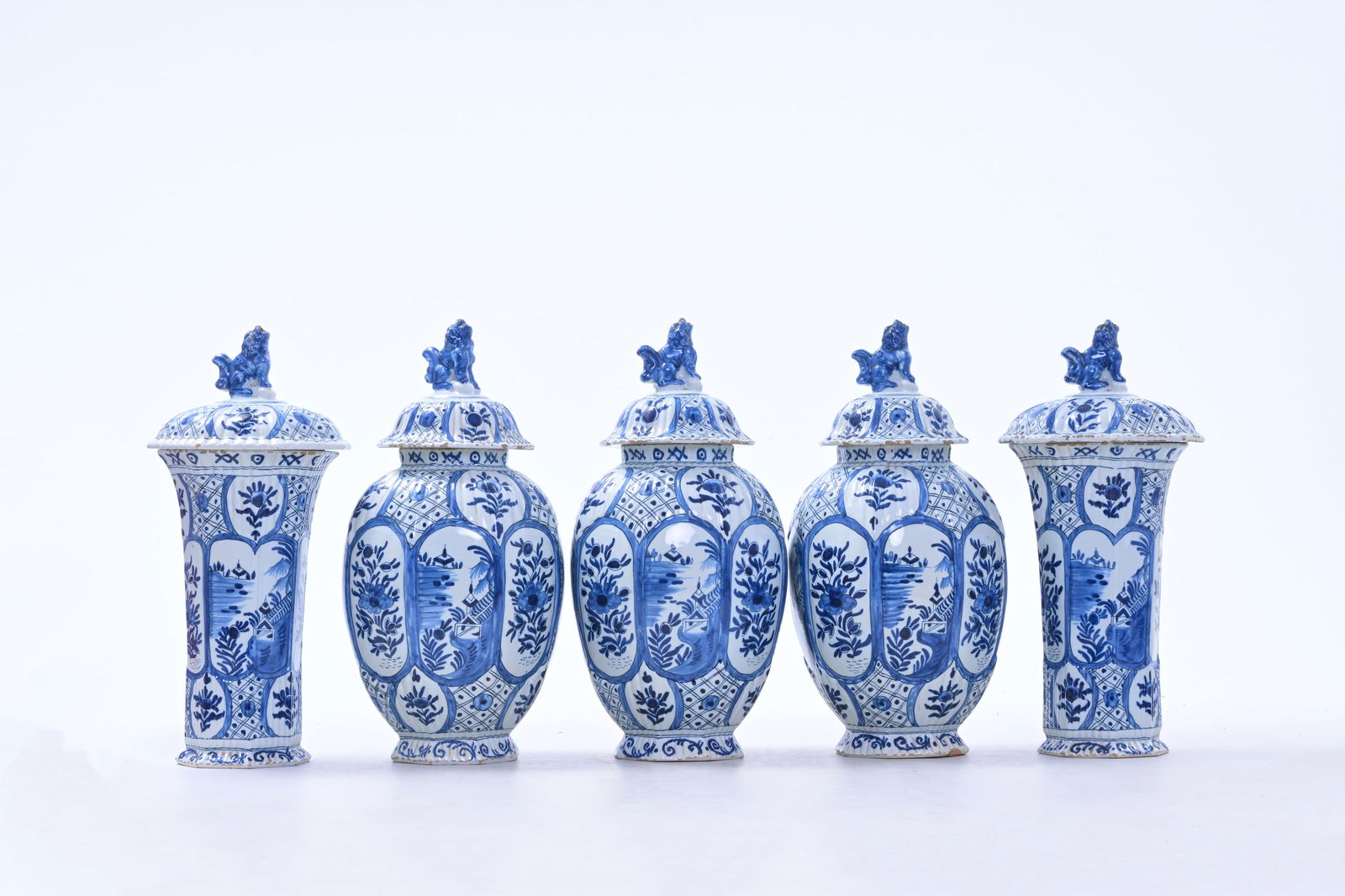 A five-piece Dutch Delft blue and white vase garniture with chinoiserie and floral design, 19th C.: A five-piece Dutch Delft blue and white vase garniture with chinoiserie and floral design, 19th C. H 35 - 34 cm (the largest and the smallest vase)