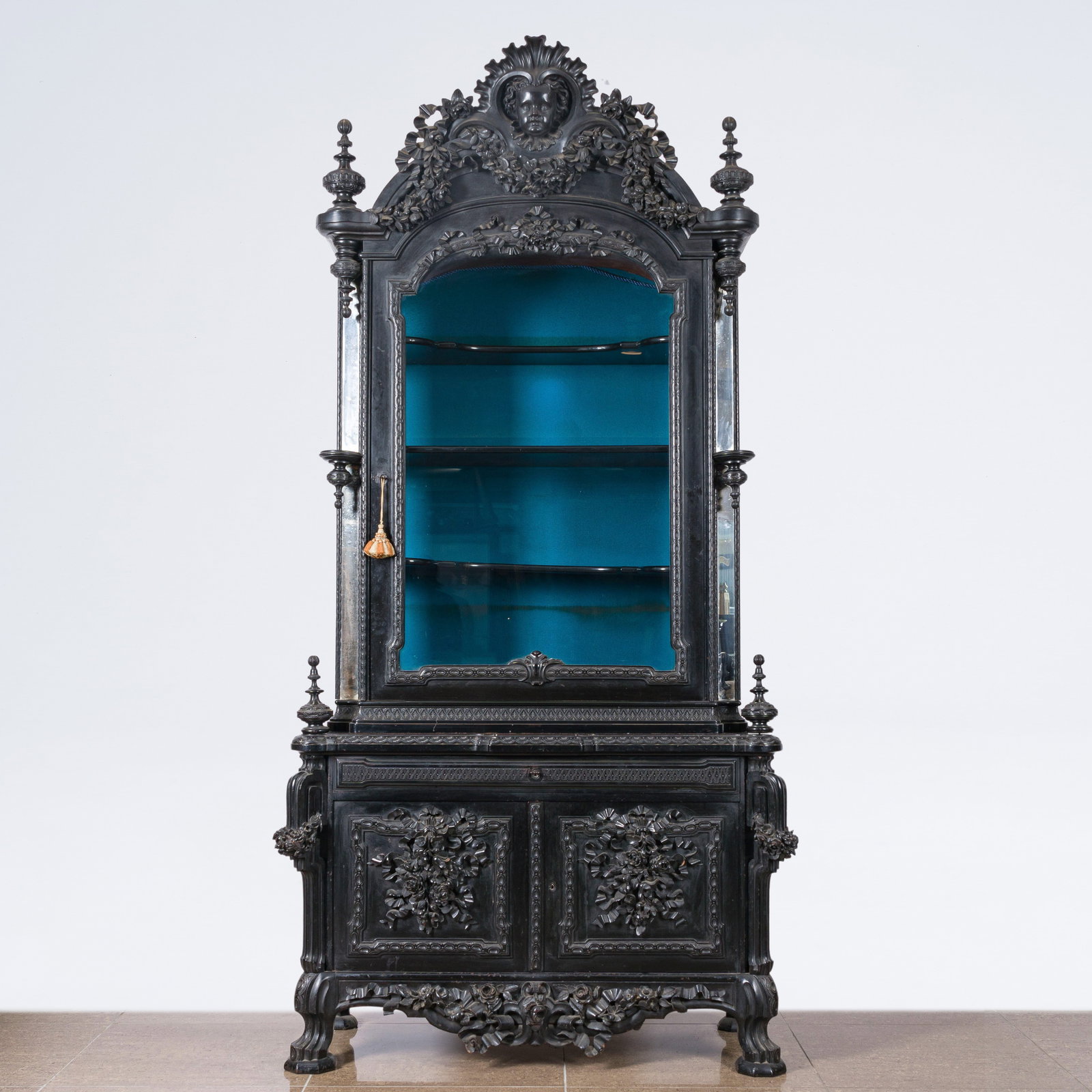 A French richly carved ebonized wooden display cabinet, 19th C.: A French richly carved ebonized wooden display cabinet, 19th C. H 249 - L 128 - D 53 cm