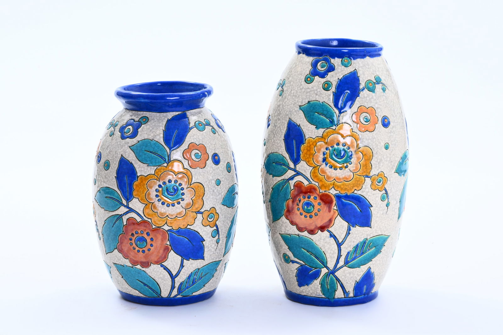Charles Catteau (1880-1966) for Boch Keramis: two Art Deco vases with polychrome floral design in a: Charles Catteau (1880-1966) for Boch Keramis: two Art Deco vases with polychrome floral design in a crackled glaze H 29 - 24,5 cm Both vases with a (partly worn) Keramis stamp, the decor number 'D.251