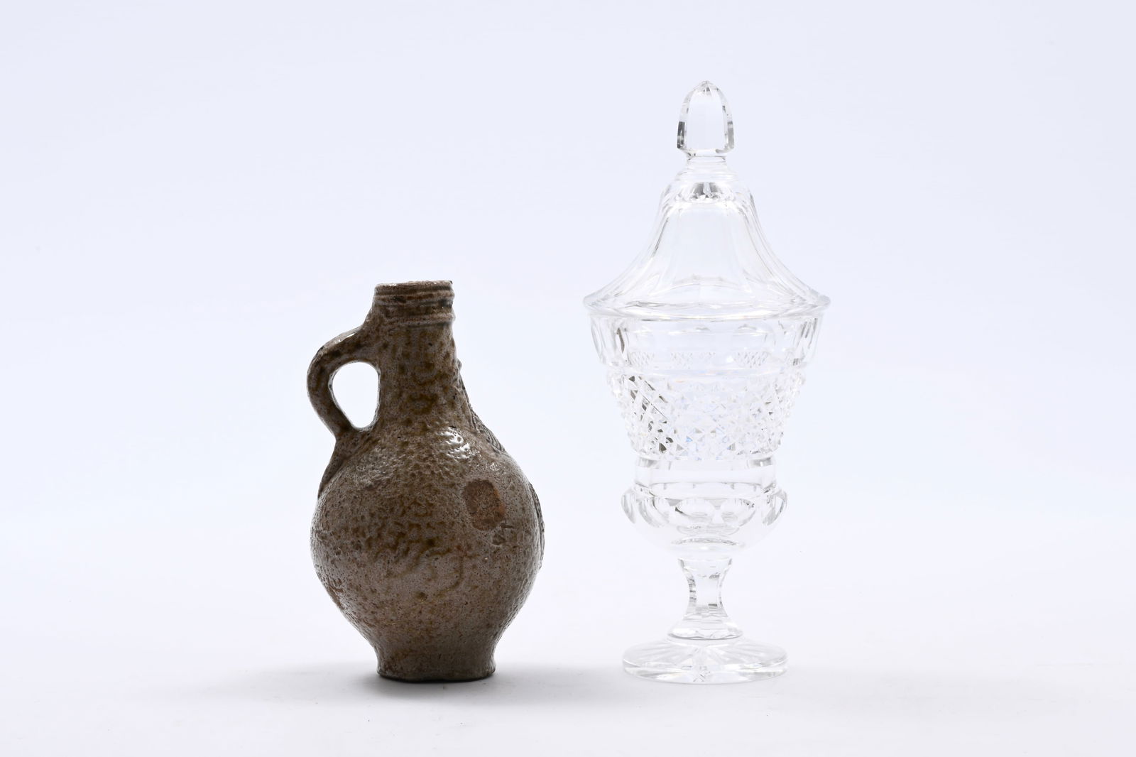 A German stoneware bellarmine jug and a crystal bonbonniere, 17th C. and 19th C. (1 of 13)