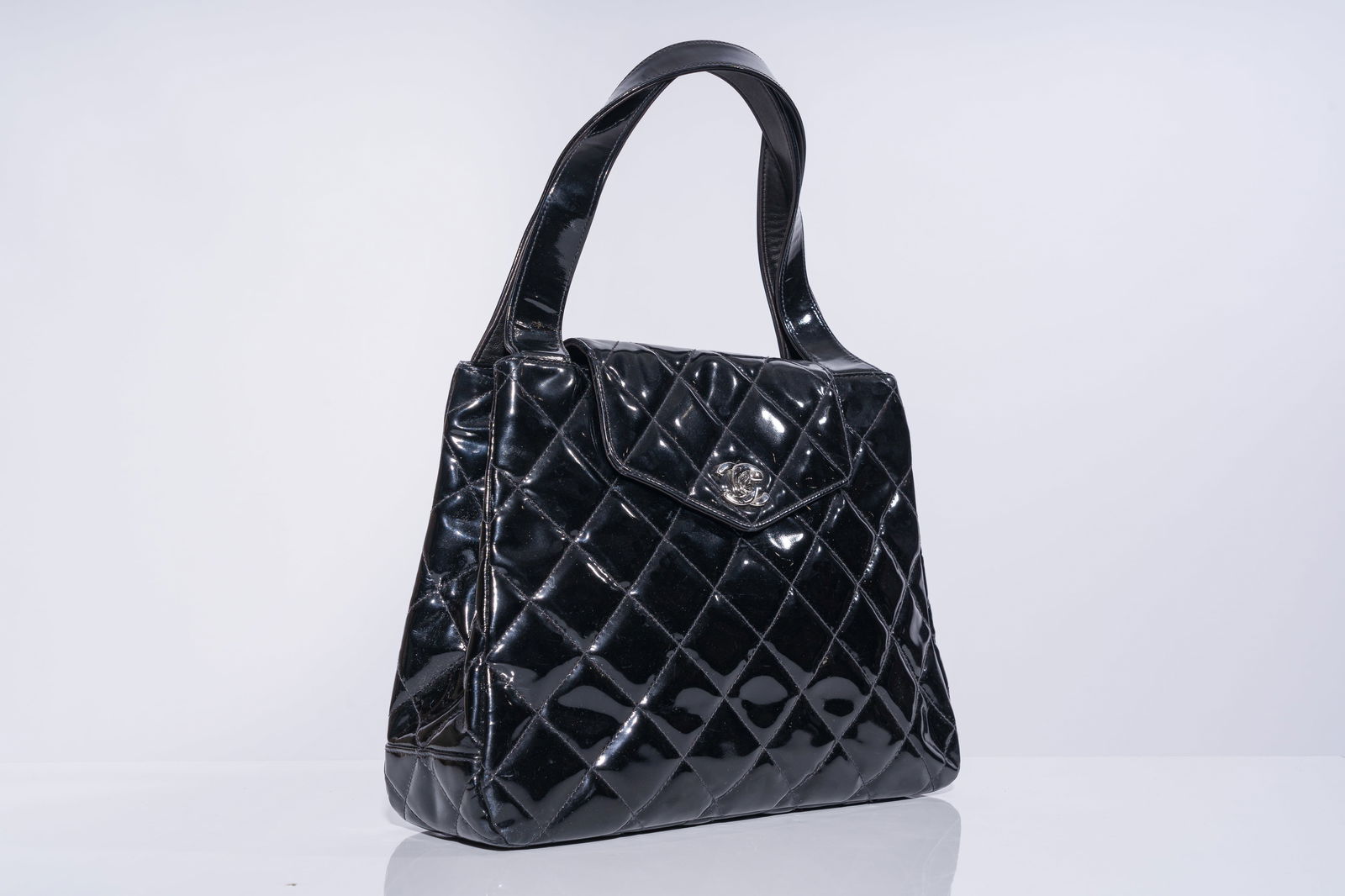 A Chanel black patent leather bag with silver coloured glasp, 1990's (1 of 8)