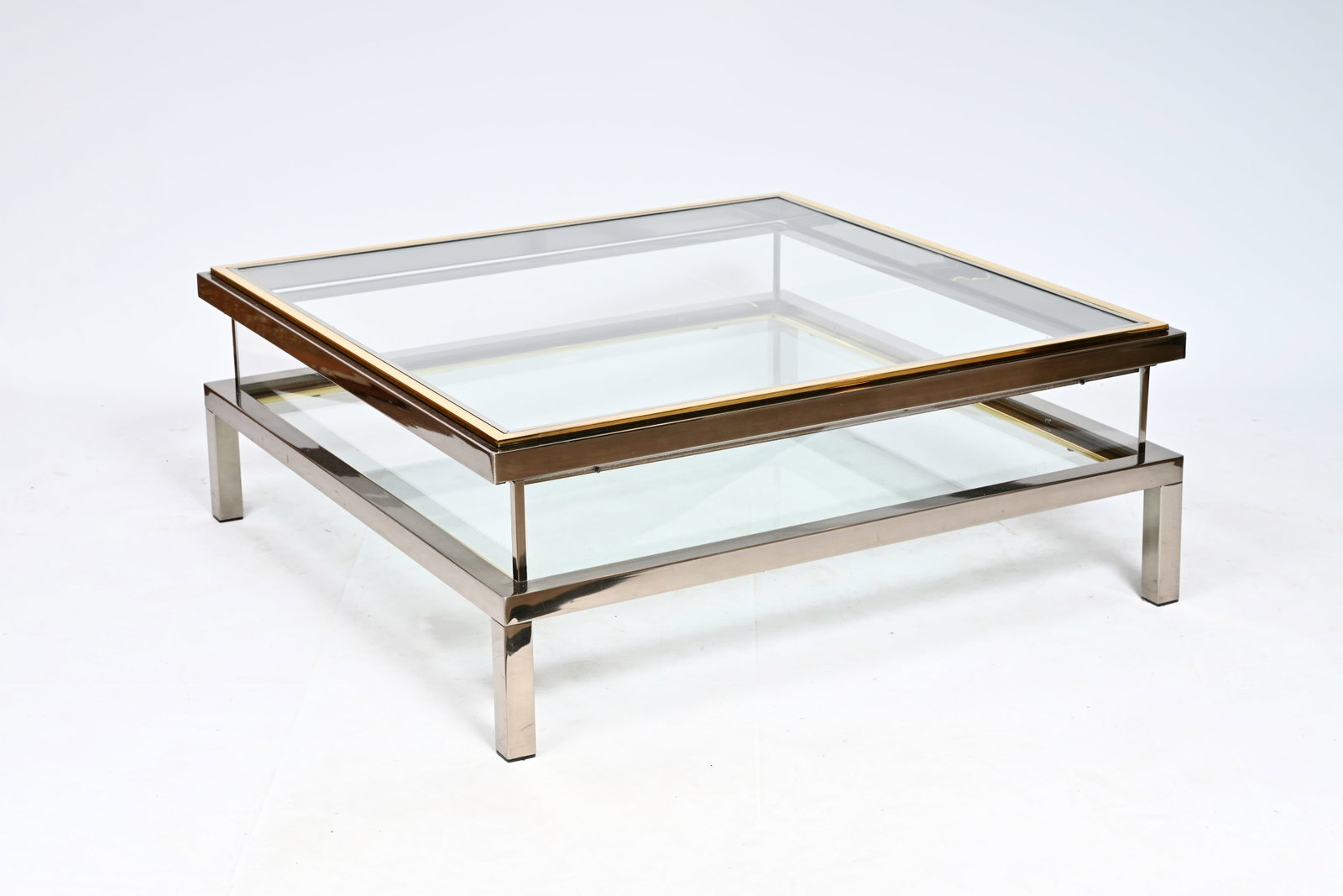 A Hollywood Regency sliding top glass, brass and polished steel coffee table, Belgo Chrom, Dewulf: A Hollywood Regency sliding top glass, brass and polished steel coffee table, Belgo Chrom, Dewulf Selection, 1970's H 40 - L 108 - D 108 cm