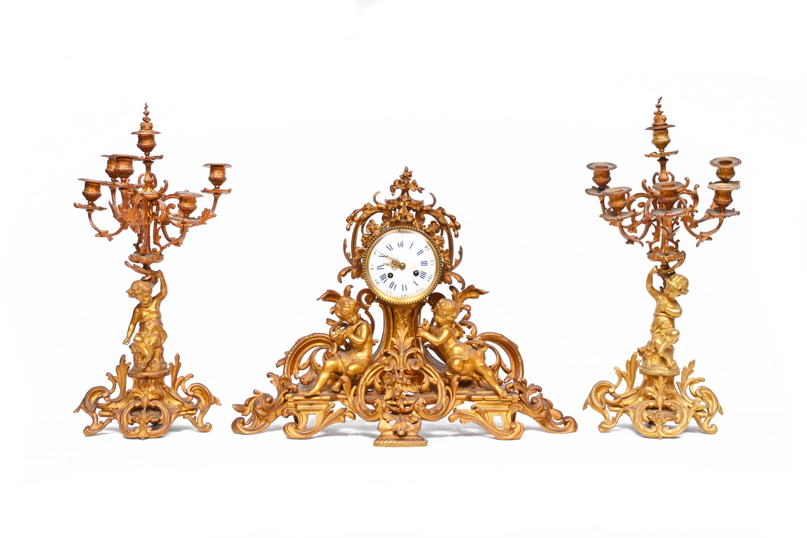 A French gilt bronze three-piece clock garniture with putti and floral design, 19th C. (1 of 7)