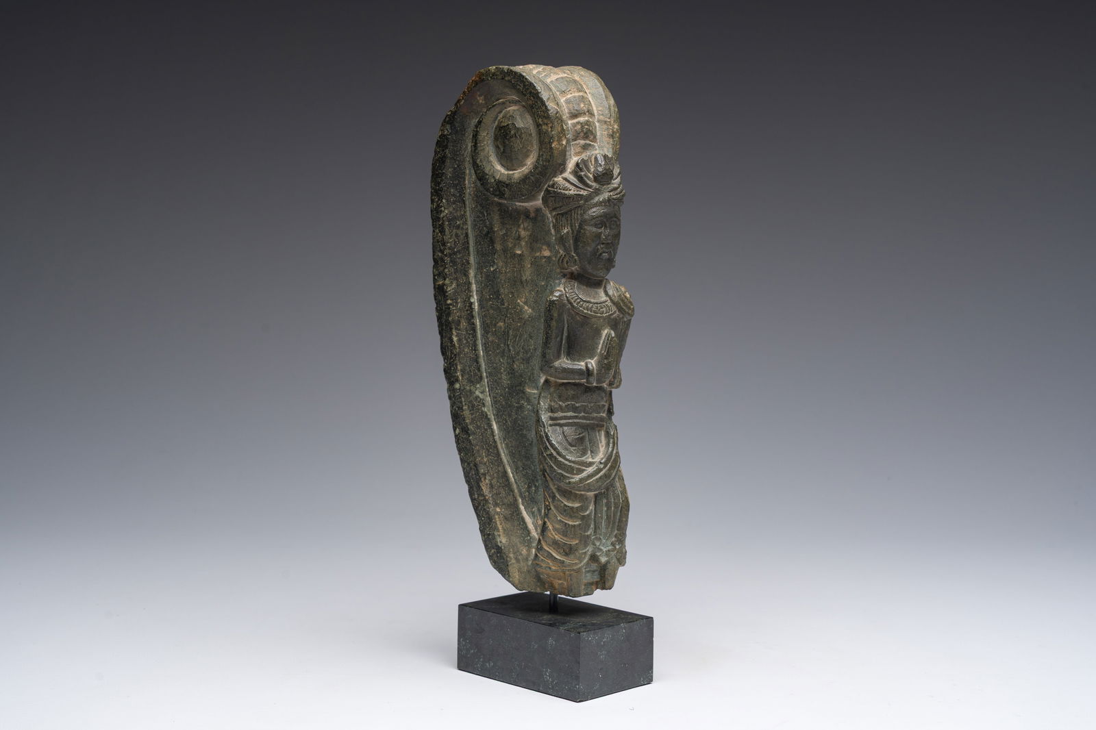 A green schist sculpture of a standing Bodhisattva Maitreya in namaste pose, Swat valley, 2nd/3rd C.: A green schist sculpture of a standing Bodhisattva Maitreya in namaste pose, Swat valley, 2nd/3rd C. H 28,2 - 24 cm (with and without base) Provenance: - The collection of Mr. and Mrs. S., Ghent. - Ac