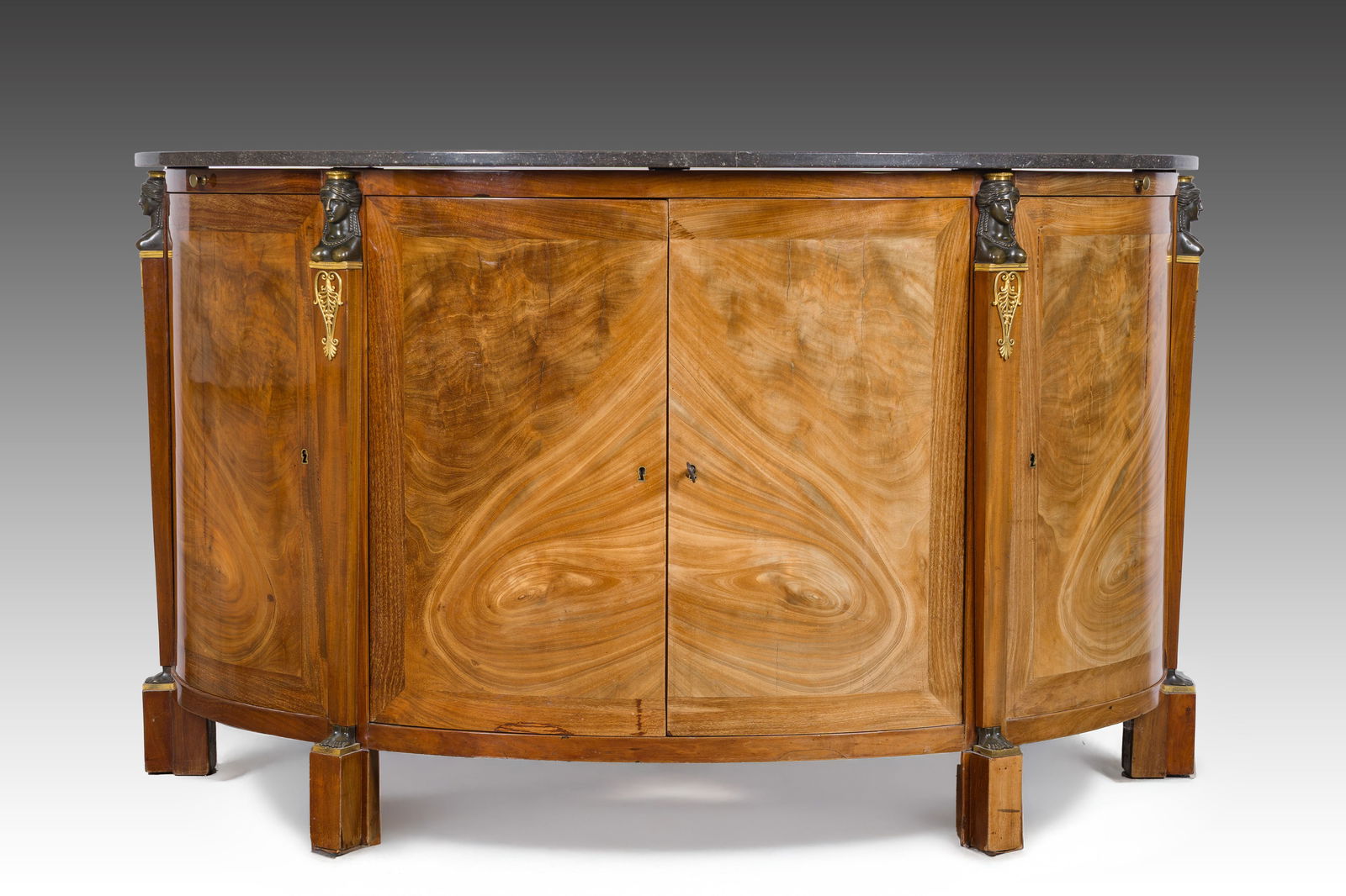 Jean Joseph Chapuis (1765-1864): A marble topped demi-lune Empire flamed mahogany veneered bronze: Jean Joseph Chapuis (1765-1864): A marble topped demi-lune Empire flamed mahogany veneered bronze mounted sideboard H 100 x L 167 x D 66 cm Bearing four marks of this iconic Belgian furniture master.