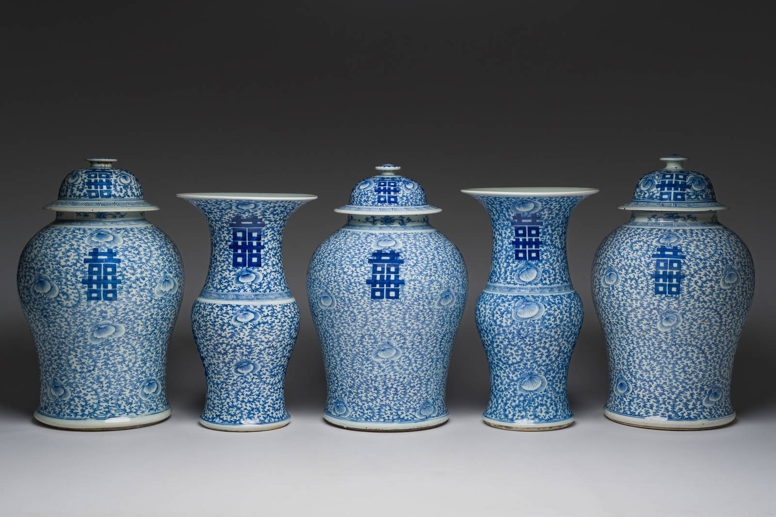 A Chinese blue and white garniture of five 'Shou' design vases, Chenghua mark, 19th C.