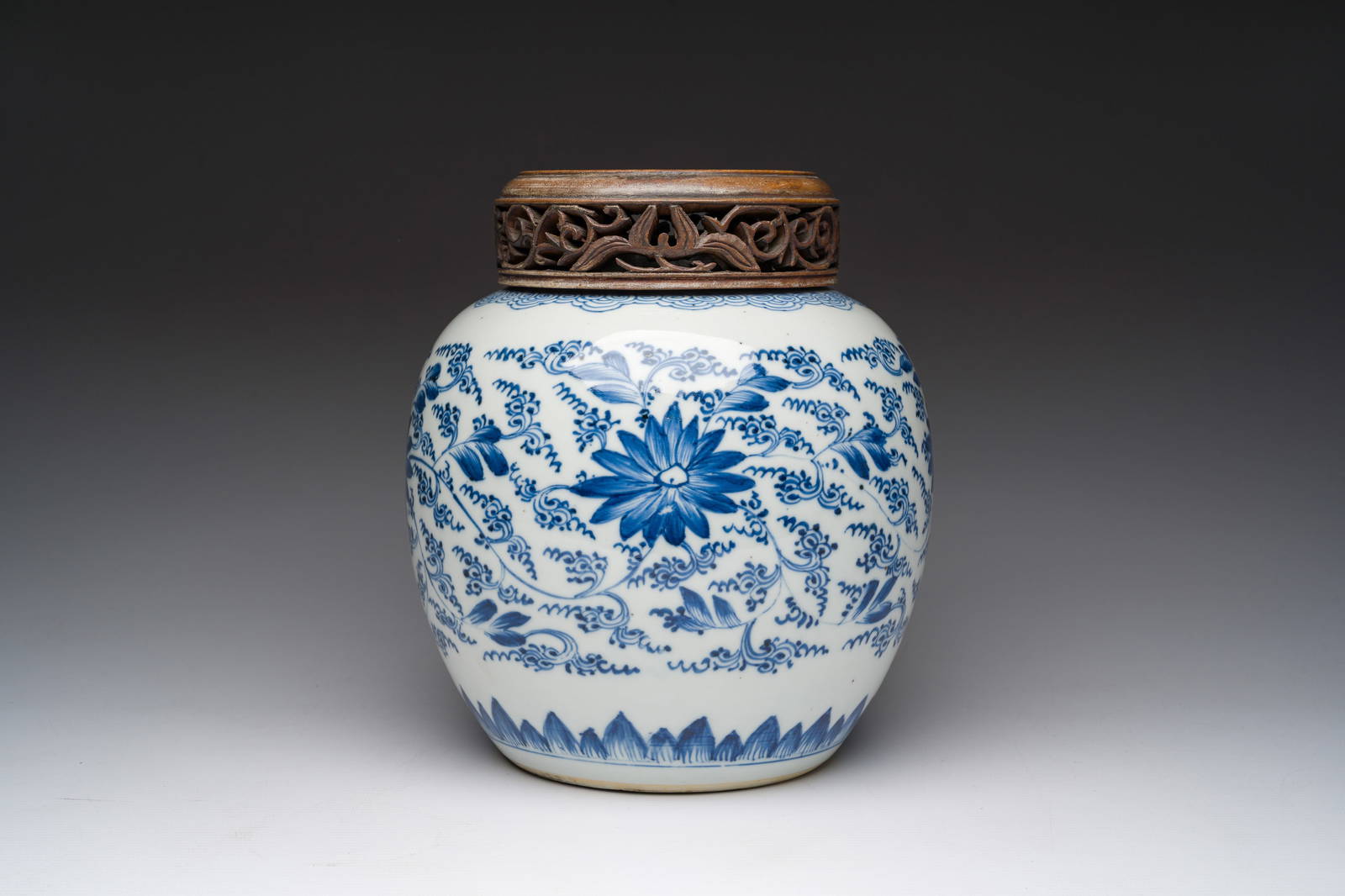 A Chinese blue and white jar with reticulated wooden cover, Kangxi