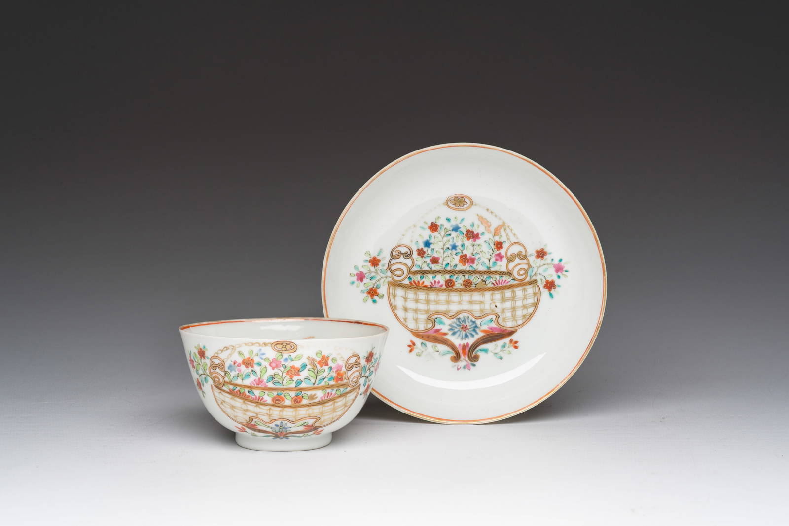 A Chinese famille rose 'flower basket' cup and saucer, Qianlong