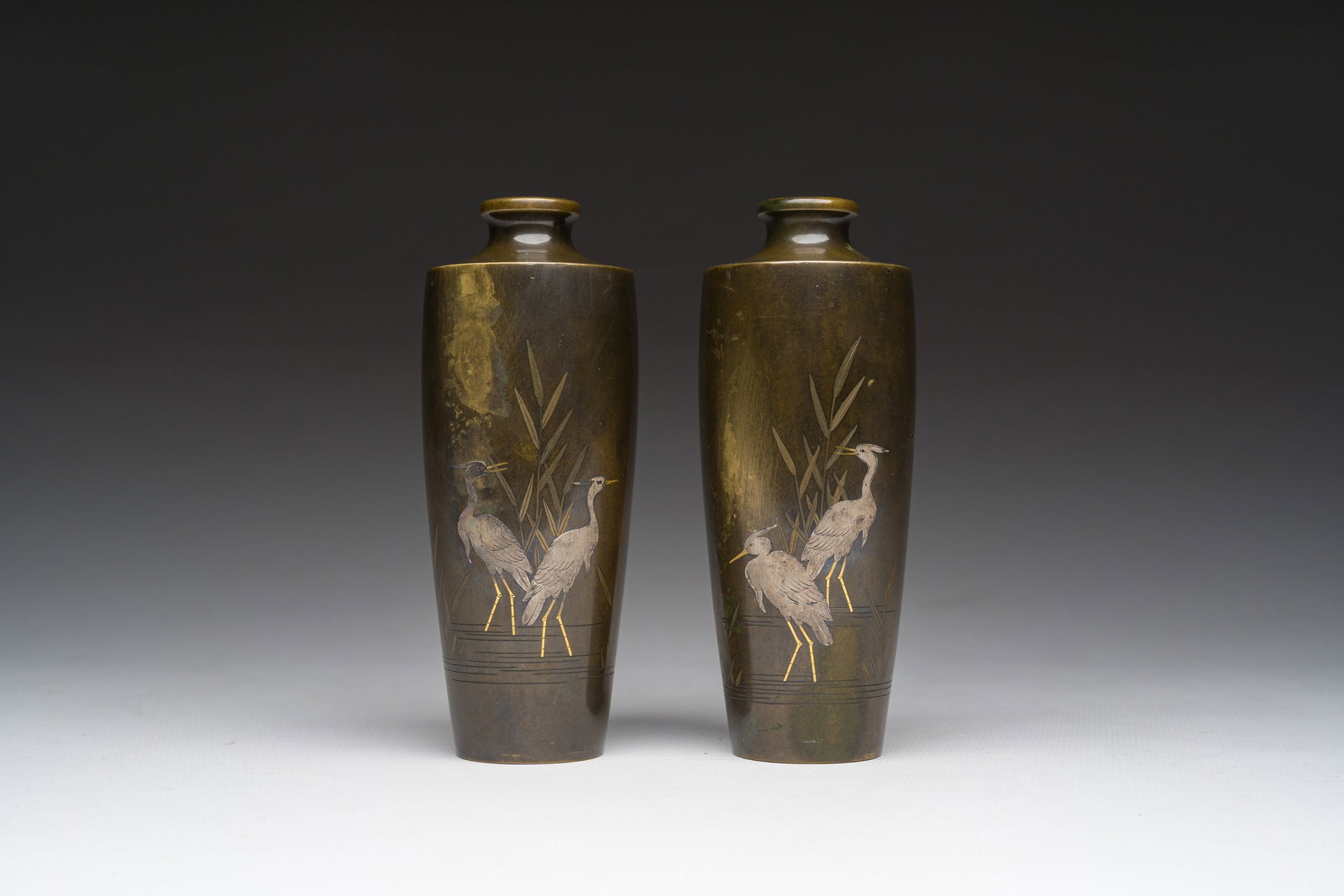 A pair of Japanese silver-inlaid bronze 'heron' vases, Nogawa Company, Meiji (1 of 6)