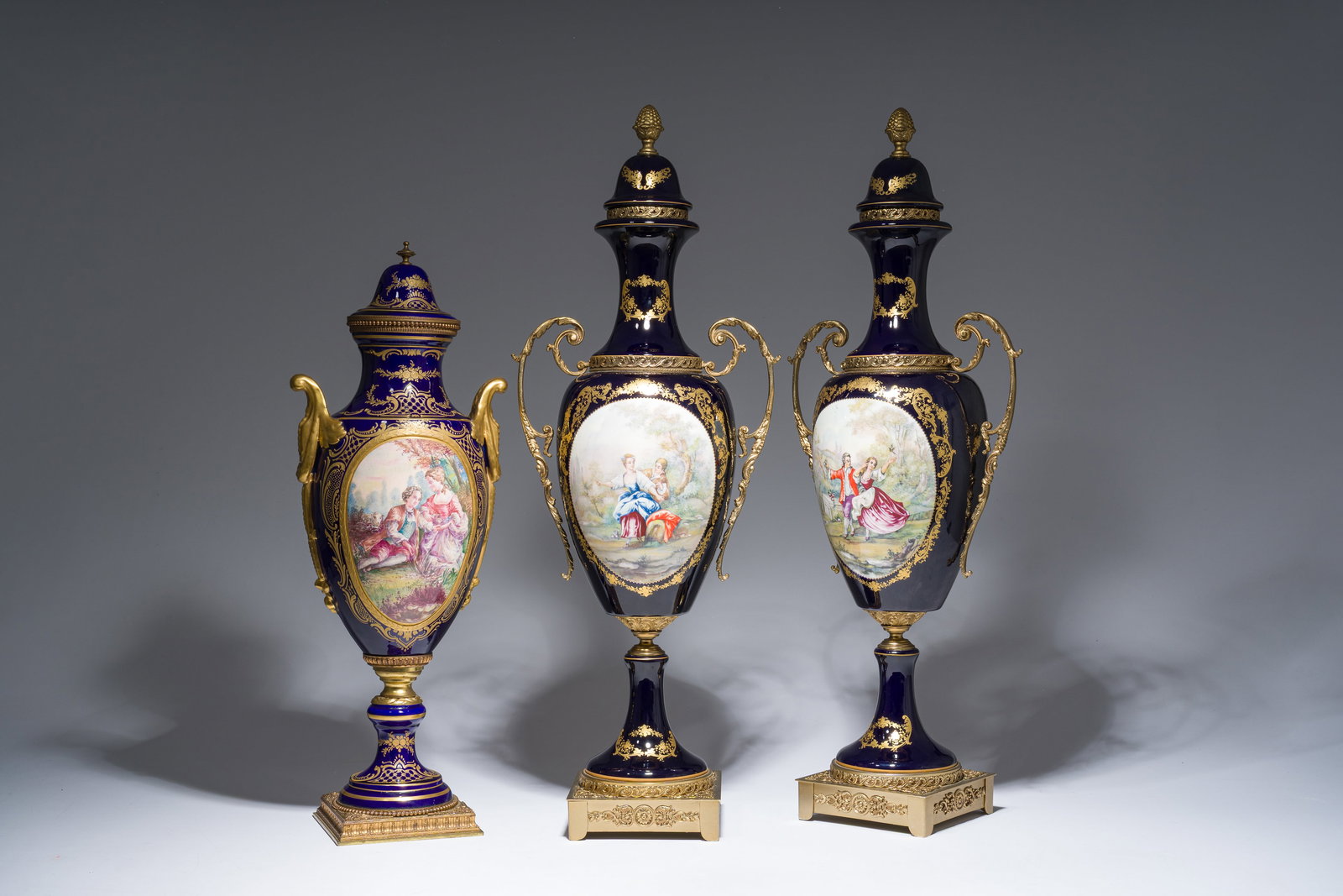 Three French gold layered blue ground gilt bronze mounted Sèvres style vases and covers with (1 of 12)