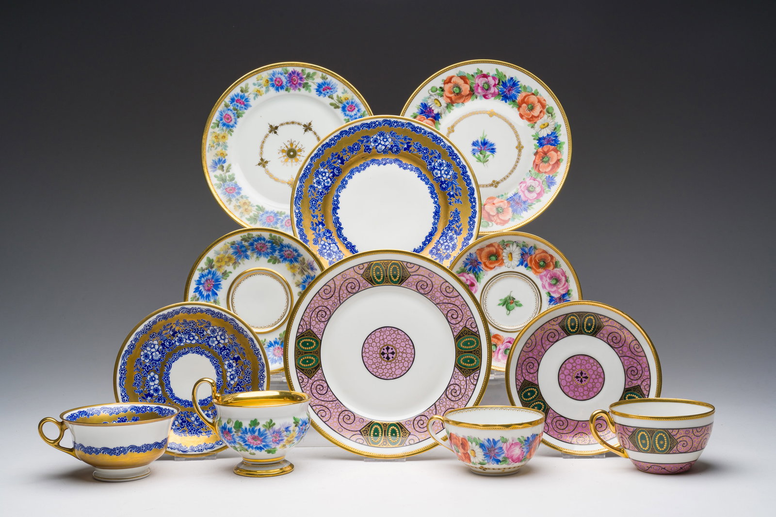 Four German polychrome and gilt decorated porcelain three-piece dinnerware sets, a.o. Ambrosius: Four German polychrome and gilt decorated porcelain three-piece dinnerware sets, a.o. Ambrosius Lamm, 19th/20th C. Dia.: 20 cm (the largest plate)Dia.: 14,5 cm (the largest saucer)H 5,5 - L 12,5 cm (t