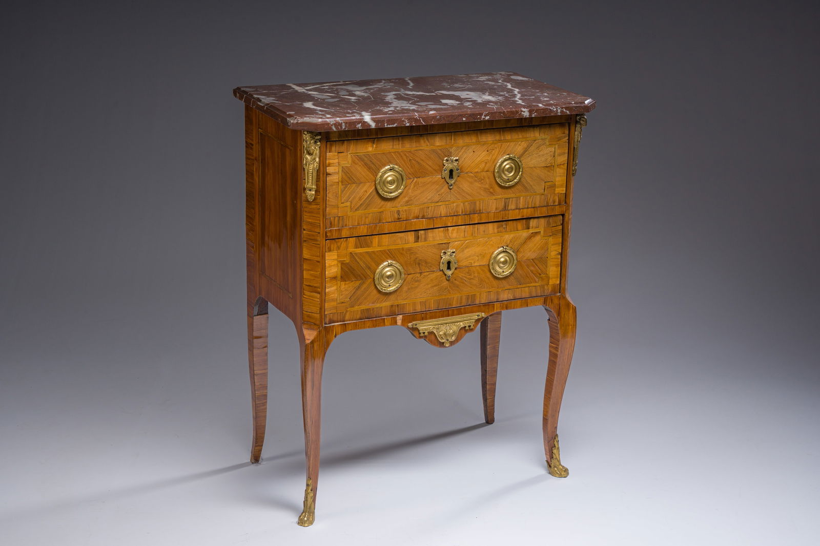 Jacques-Pierre Letellier (ca.1745-?): A mahogany veneer Louis XVI chest of drawers with gilt bronze: Jacques-Pierre Letellier (ca.1745-?): A mahogany veneer Louis XVI chest of drawers with gilt bronze mounts and red marble top H 79,5 - L 63 - D 35,5 cm