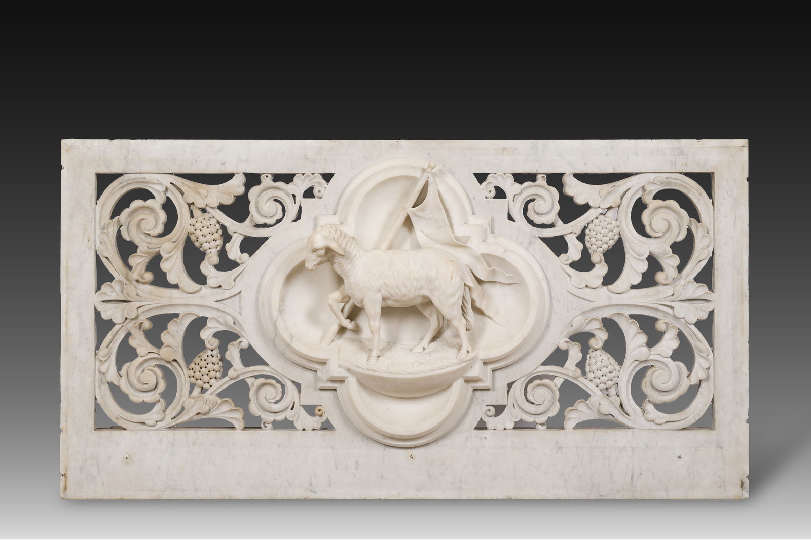 A Gothic Revival reticulated white marble 'Agnus Dei' relief, 19th C.: A Gothic Revival reticulated white marble 'Agnus Dei' relief, 19th C. 128 x 67 cm