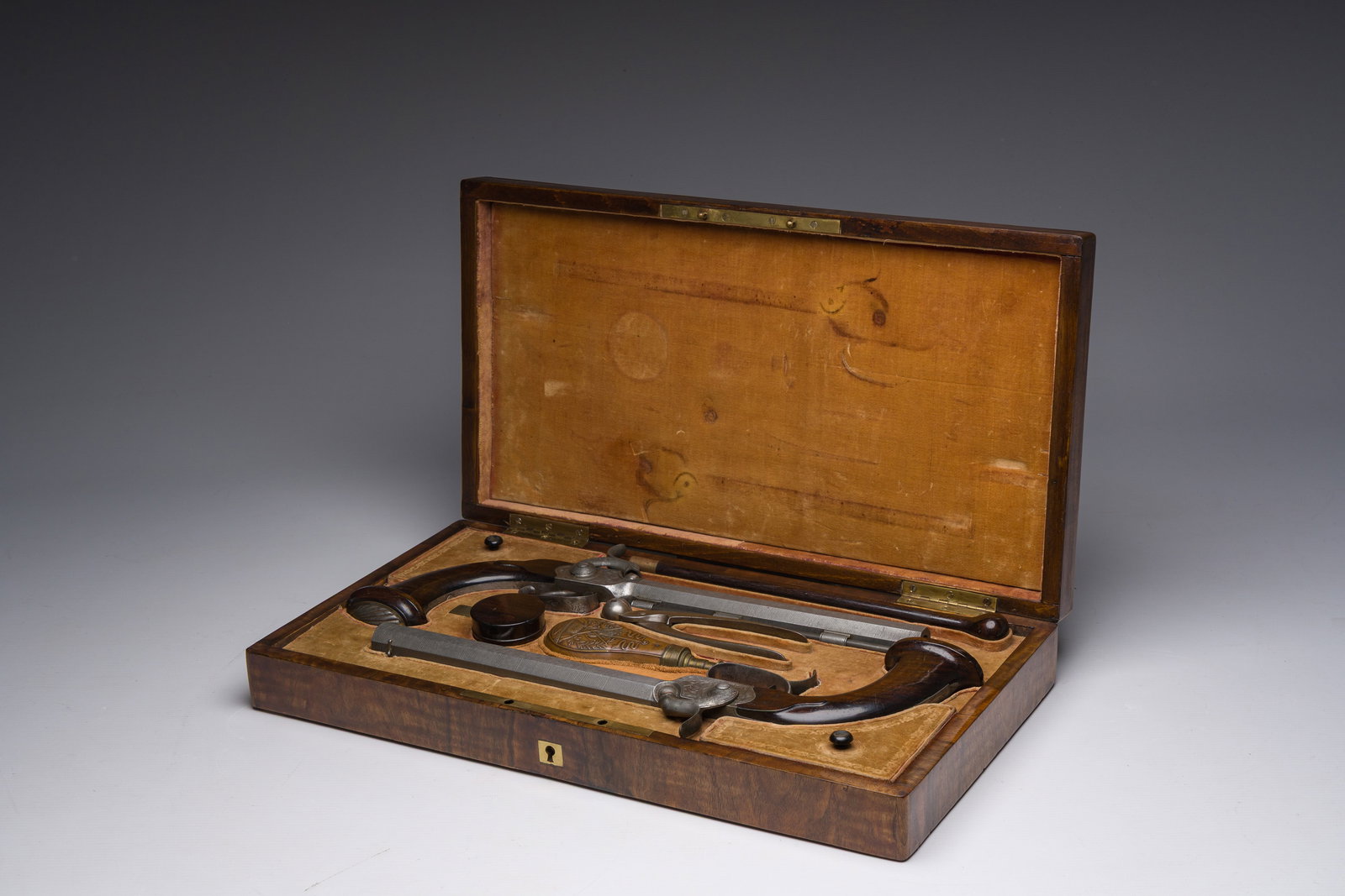 A French dueling box containing a pair of percussion pistols with damask barrels and engraved (1 of 9)